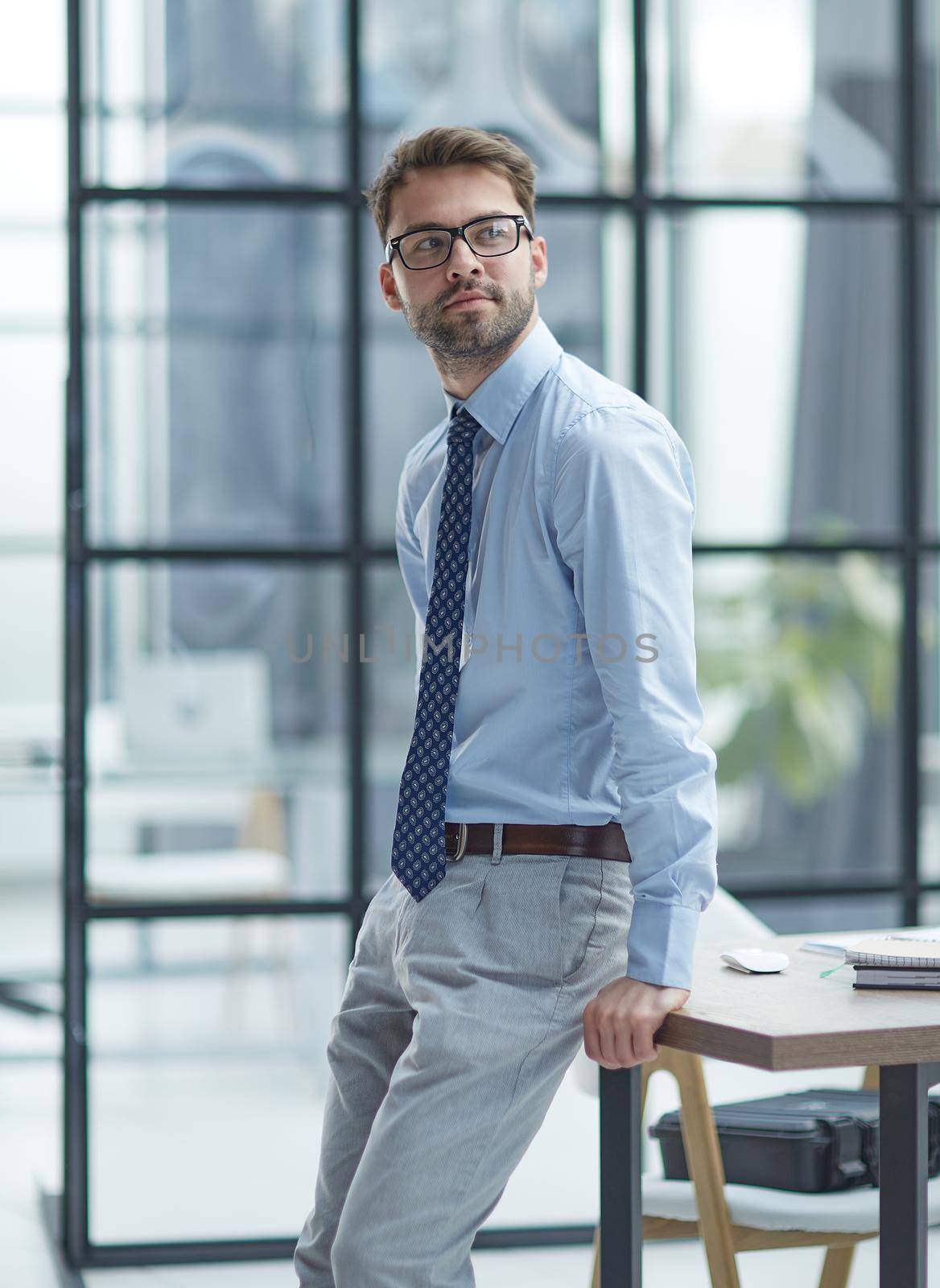 Young cheerful businessman working at office