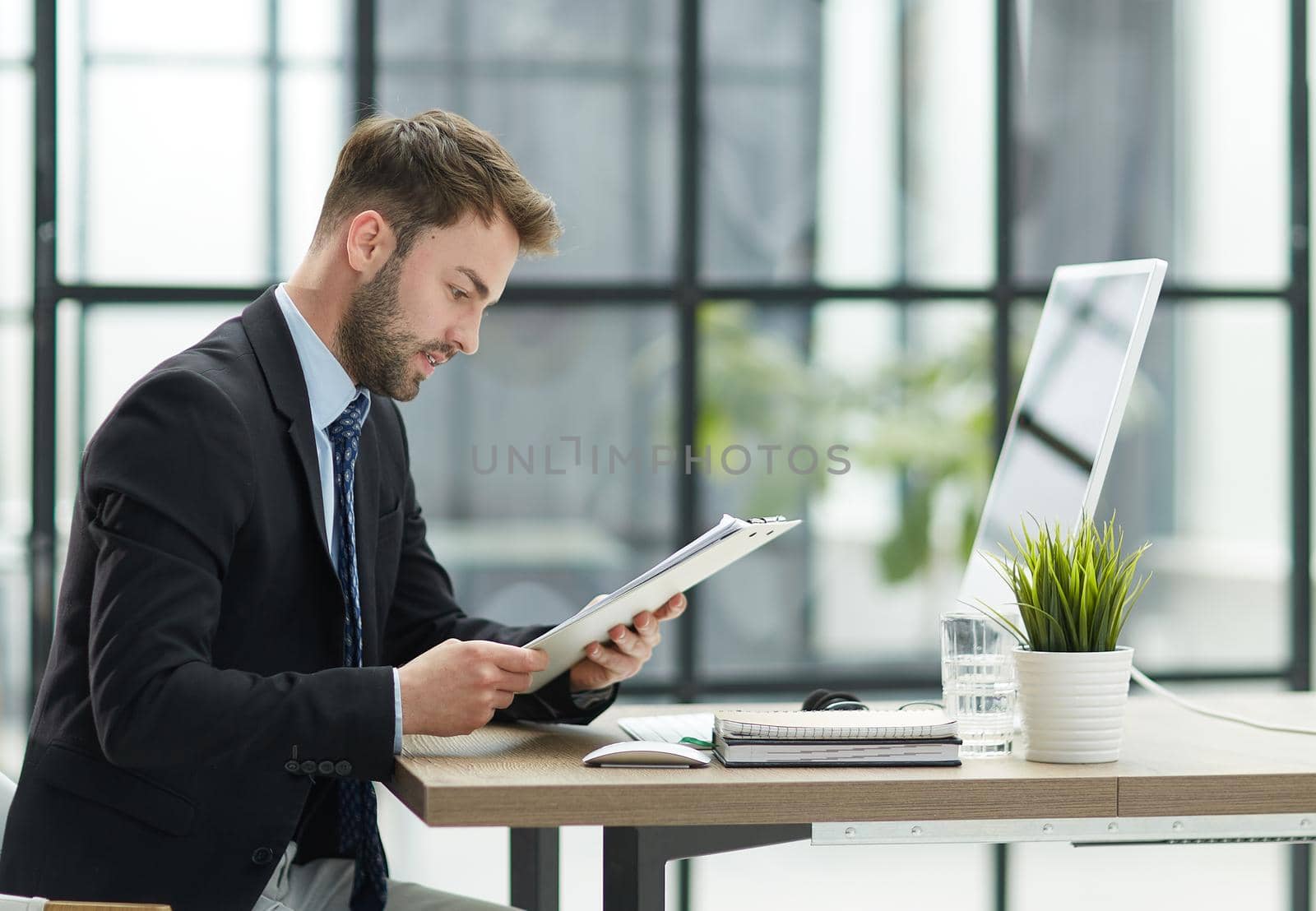 Businessman Taking Papers From Secretary In Office