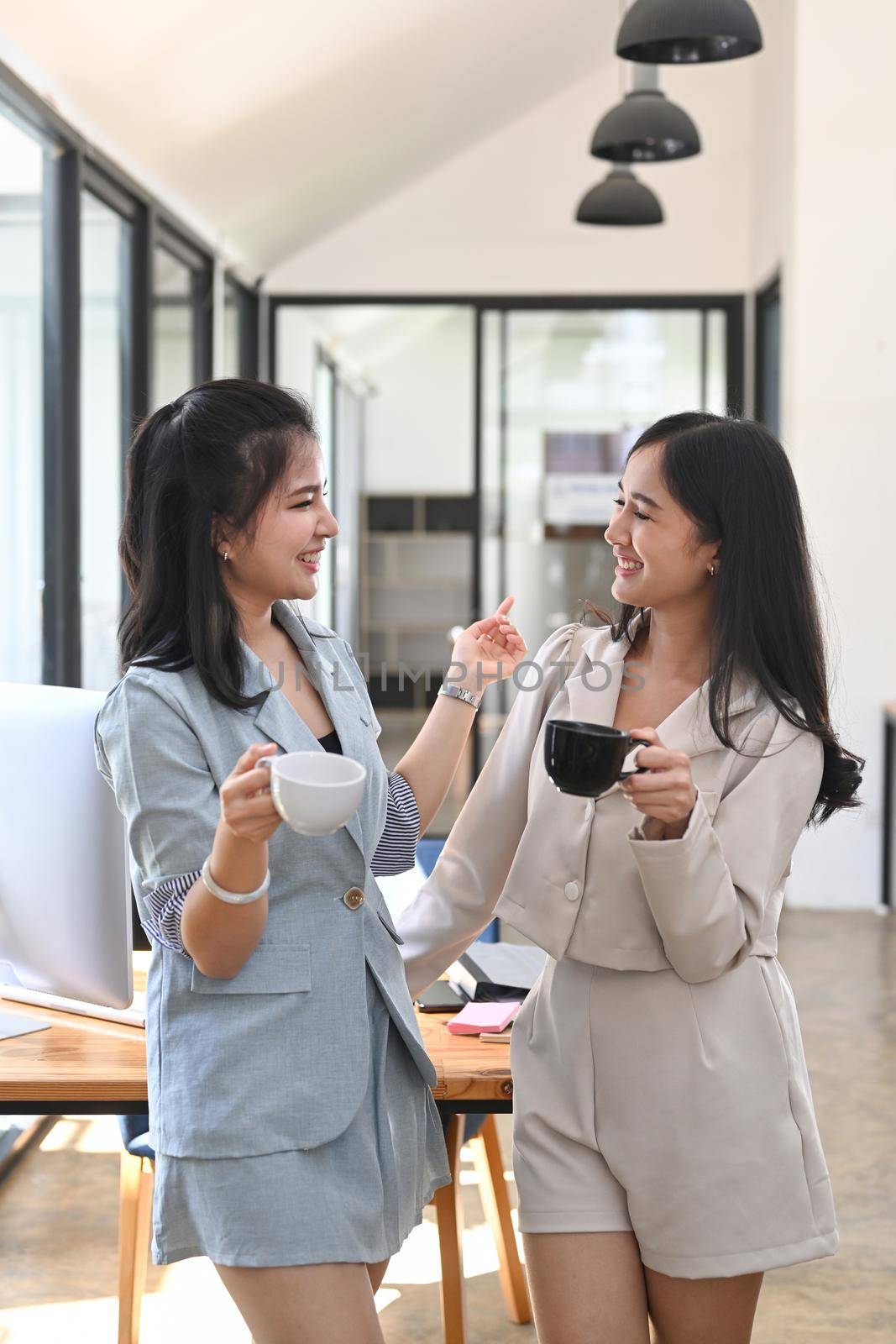 Business colleagues drinking tea or coffee during break at office. Concept of rest and break at work.