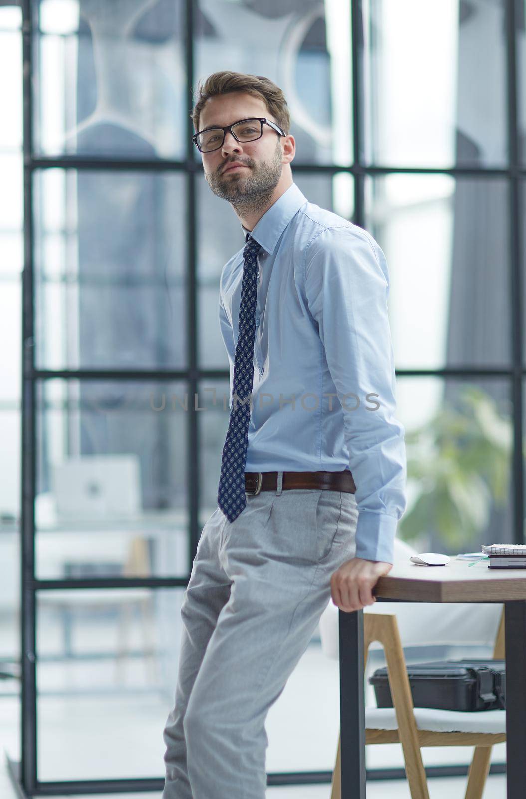 Young cheerful businessman working at office