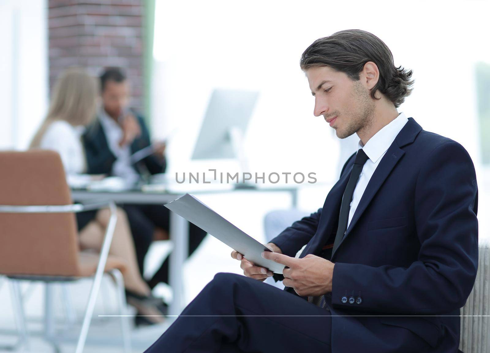 confident businessman studying the document in his office by SmartPhotoLab
