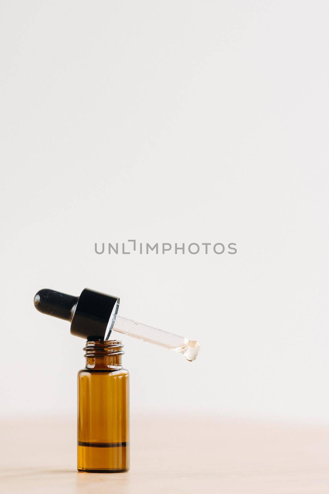 Essential oil in one bottle standing on the surface.