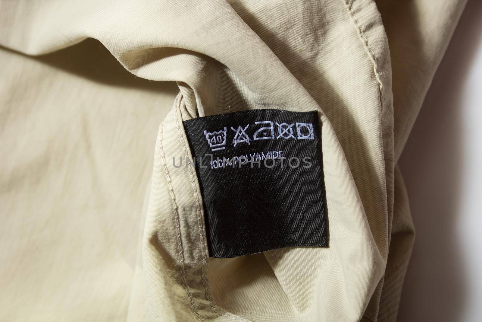 black 100 percent polyamide tag on beige hiking shirt