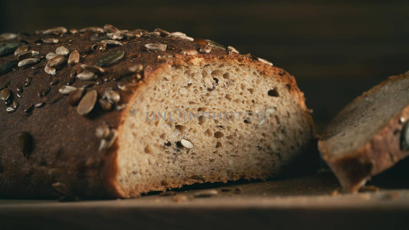 Close-up of homemade whole grain bread crumb with seeds. Selective focus.