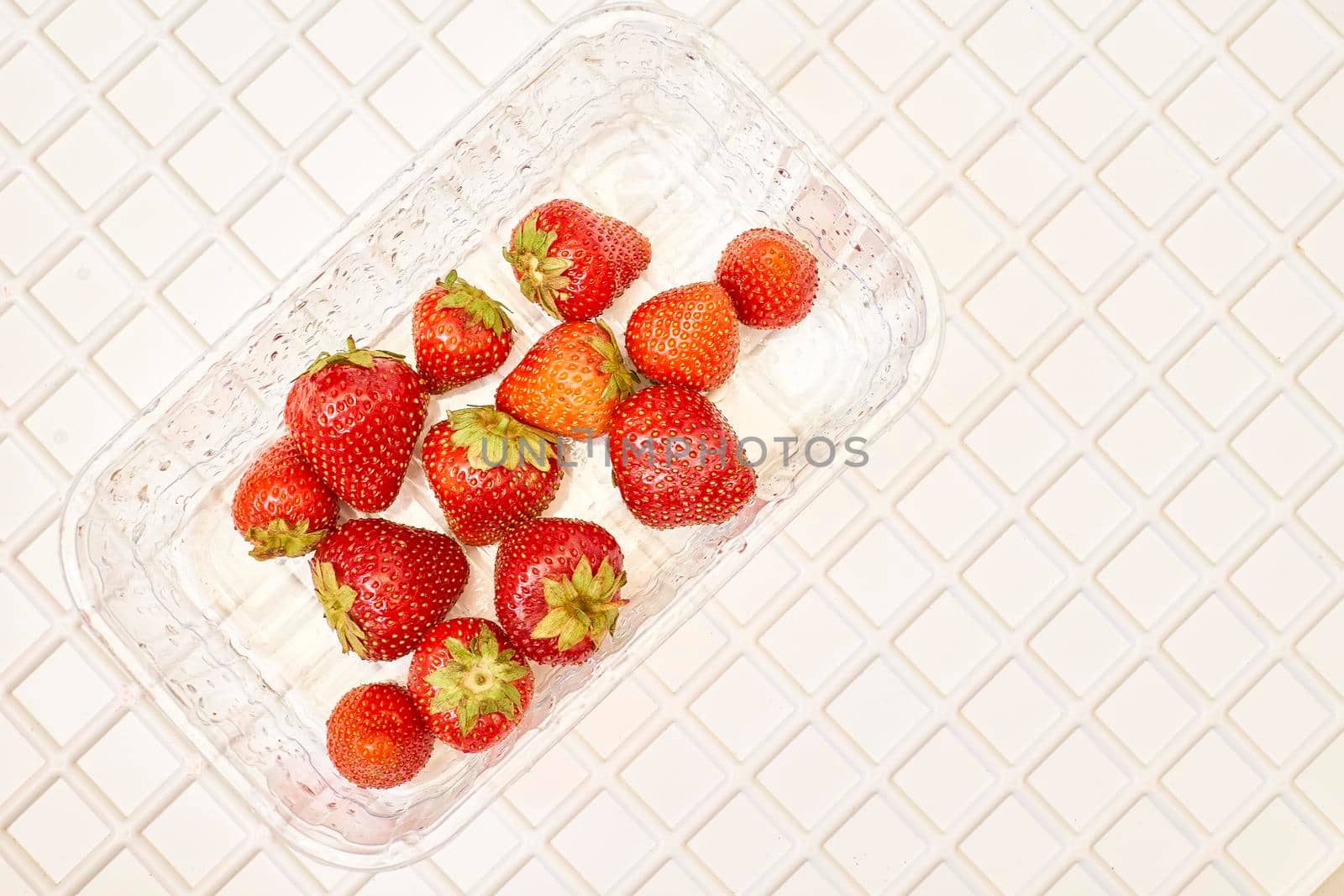 Plastic basket with fresh juicy strawberries.Tasty and healthy by jovani68