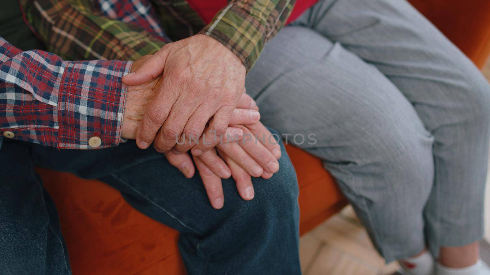 Close up of caring elderly grandmother wife holding hands supporting senior grandfather husband give empathy care love, old married grandparents couple together two man and woman hope understanding