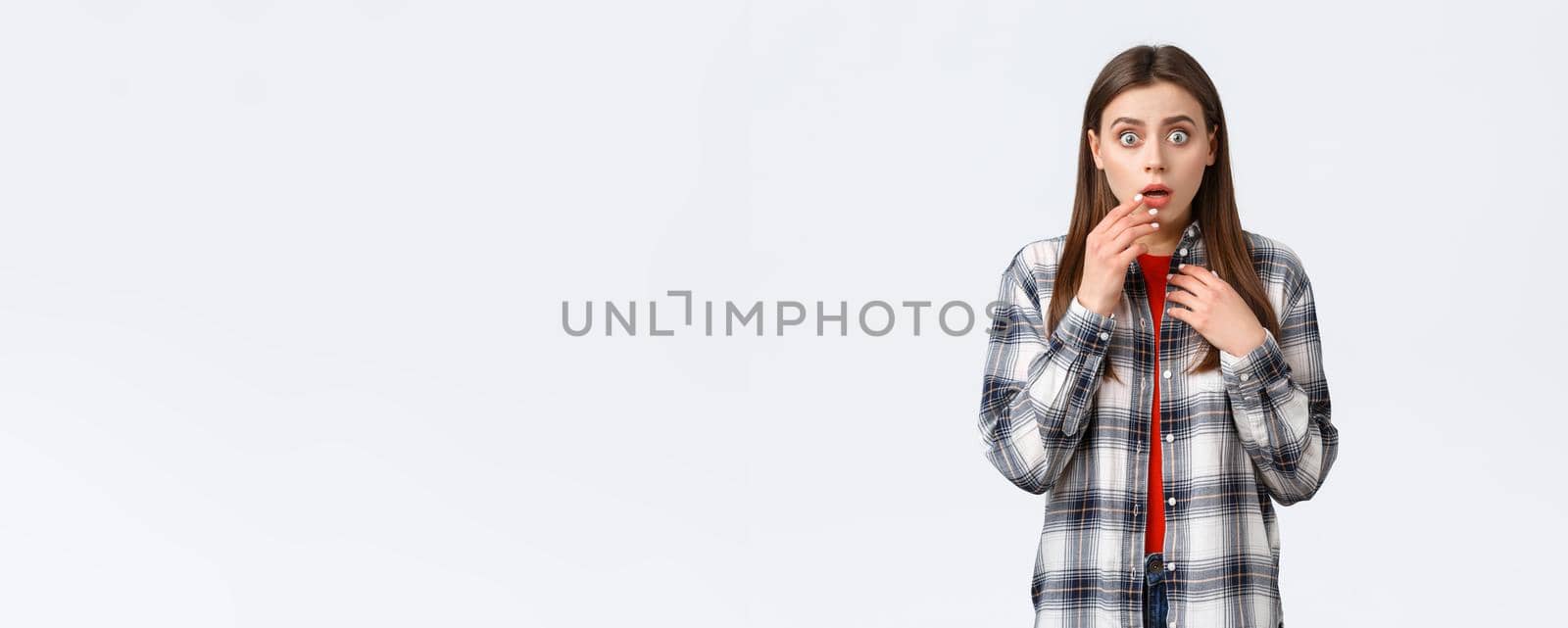 Lifestyle, different emotions, leisure activities concept. Worried and concerned woman hear bad news, express compassion and shock, gasping cover opened mouth palm and staring camera by Benzoix