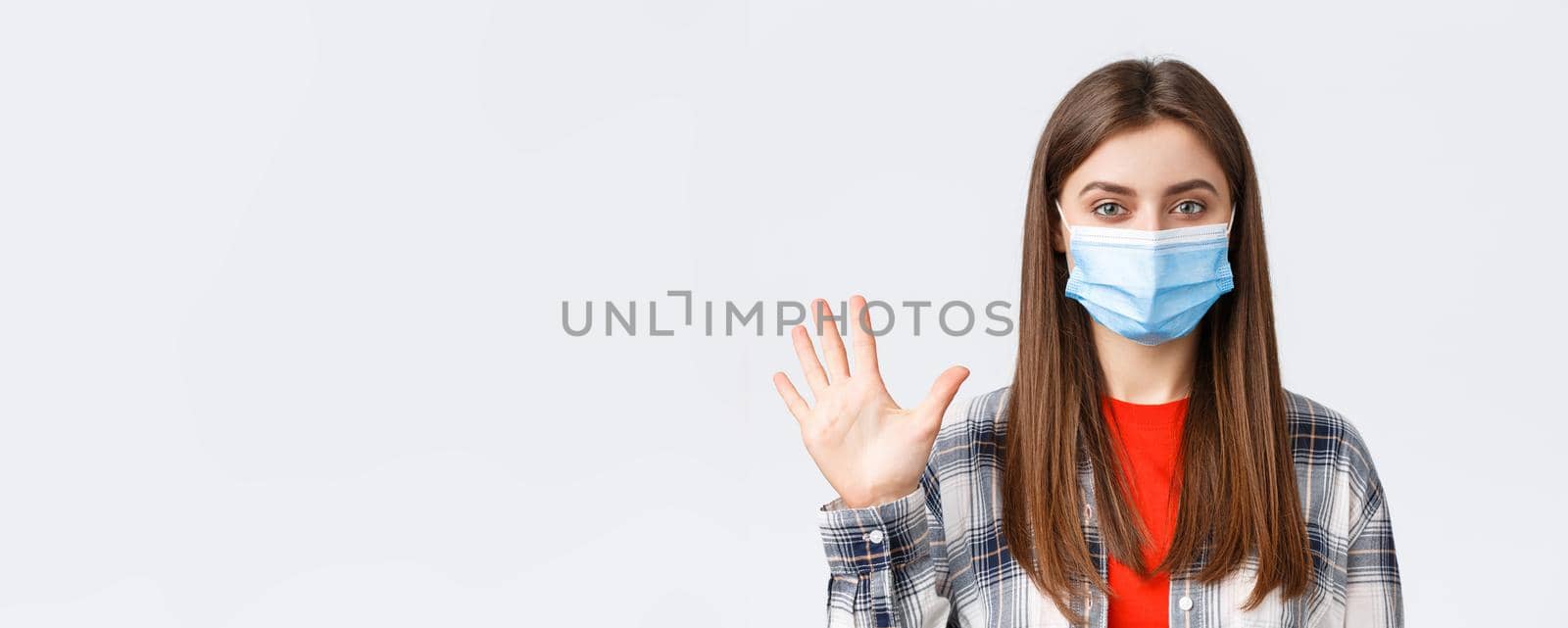 Coronavirus outbreak, leisure on quarantine, social distancing and emotions concept. Attractive female in medical mask and casual clothes show five fingers, number of order, white background.