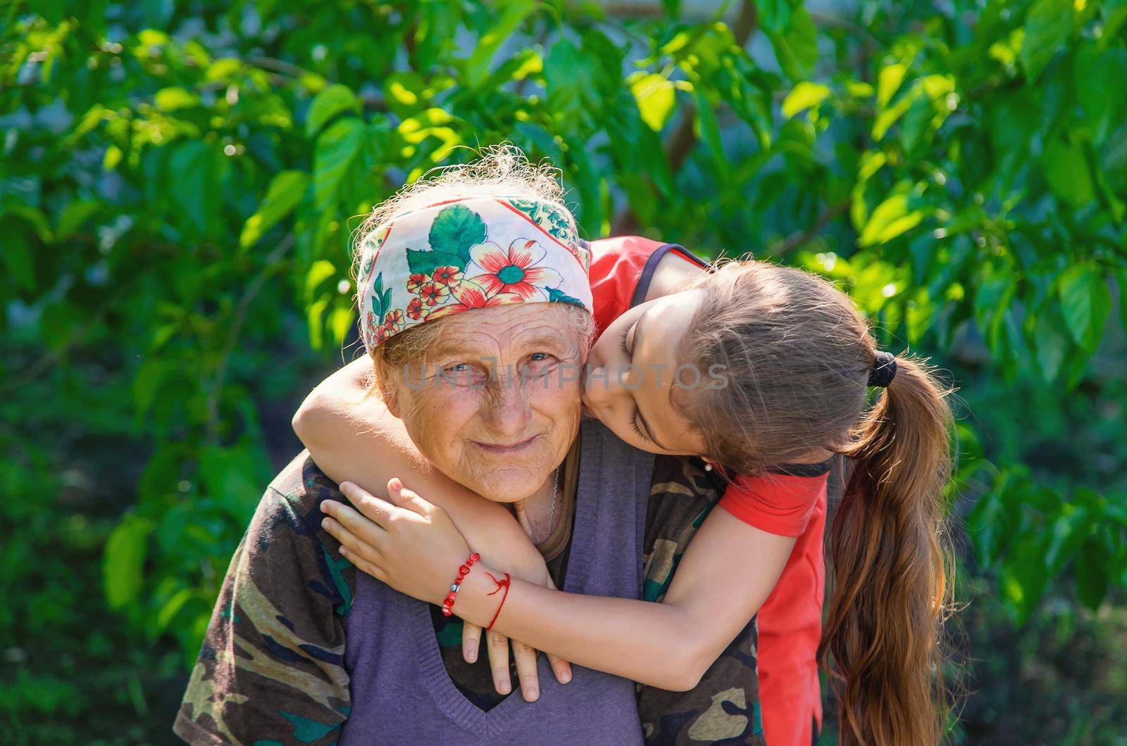 Granddaughter hugs and loves her grandmother. Selective focus. by yanadjana
