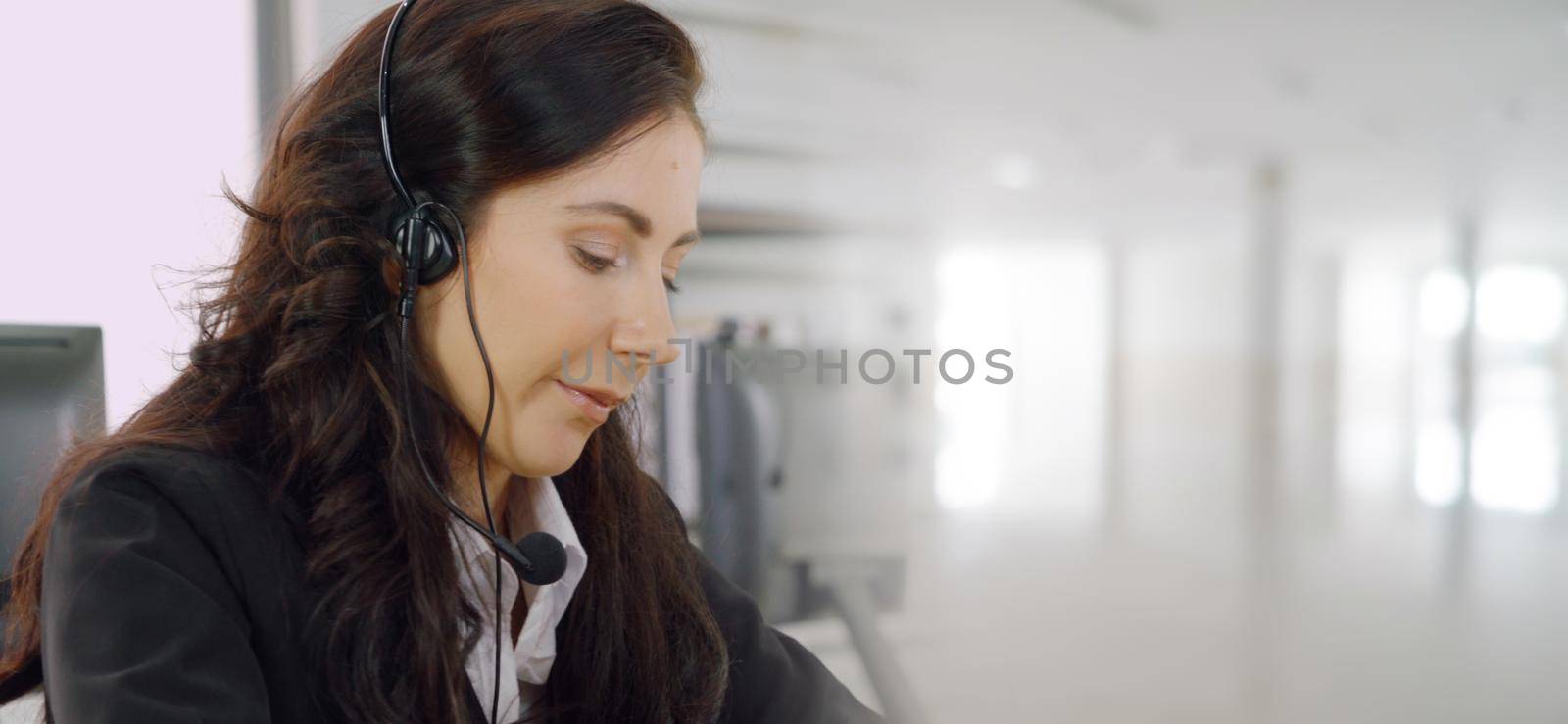 Business people wearing headset working in office to support remote customer or colleague. Call center, telemarketing, customer support agent provide service in broaden view .