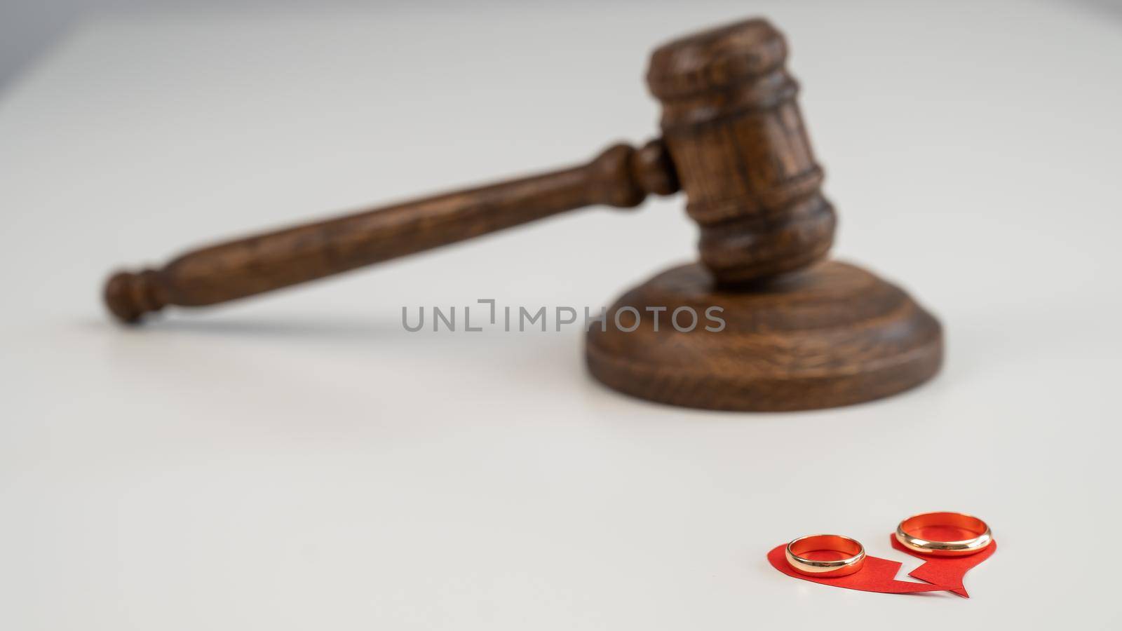 Judicial gavel broken heart and wedding rings. by mrwed54