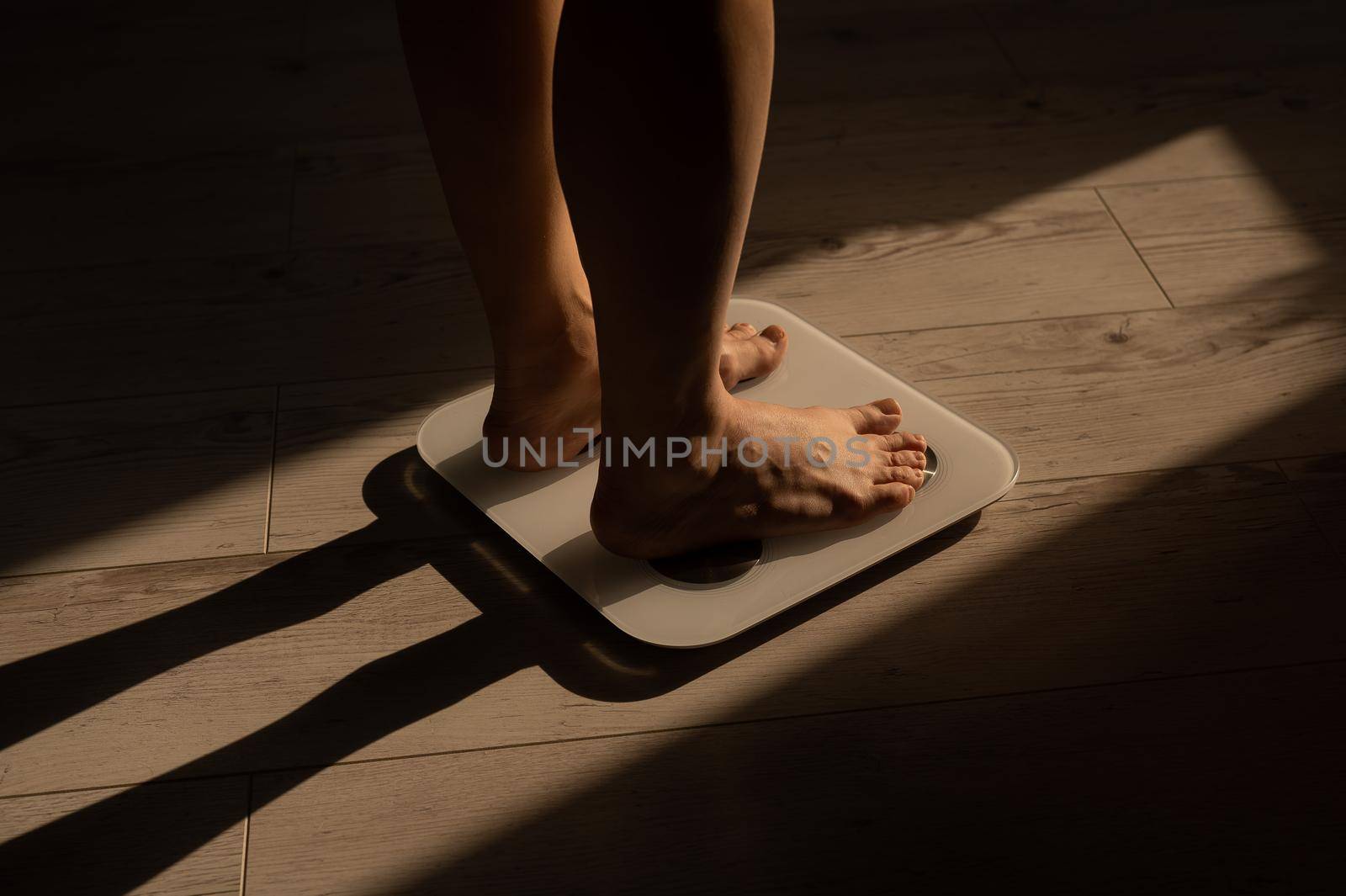 Close-up of female legs on electronic scales