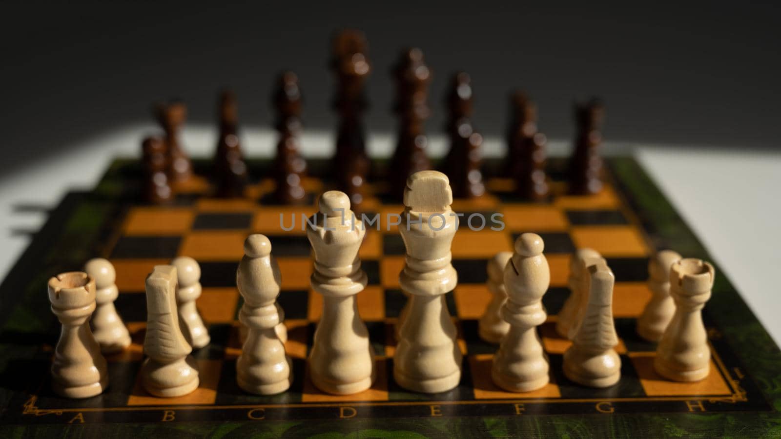 Chessboard with pieces on a white table