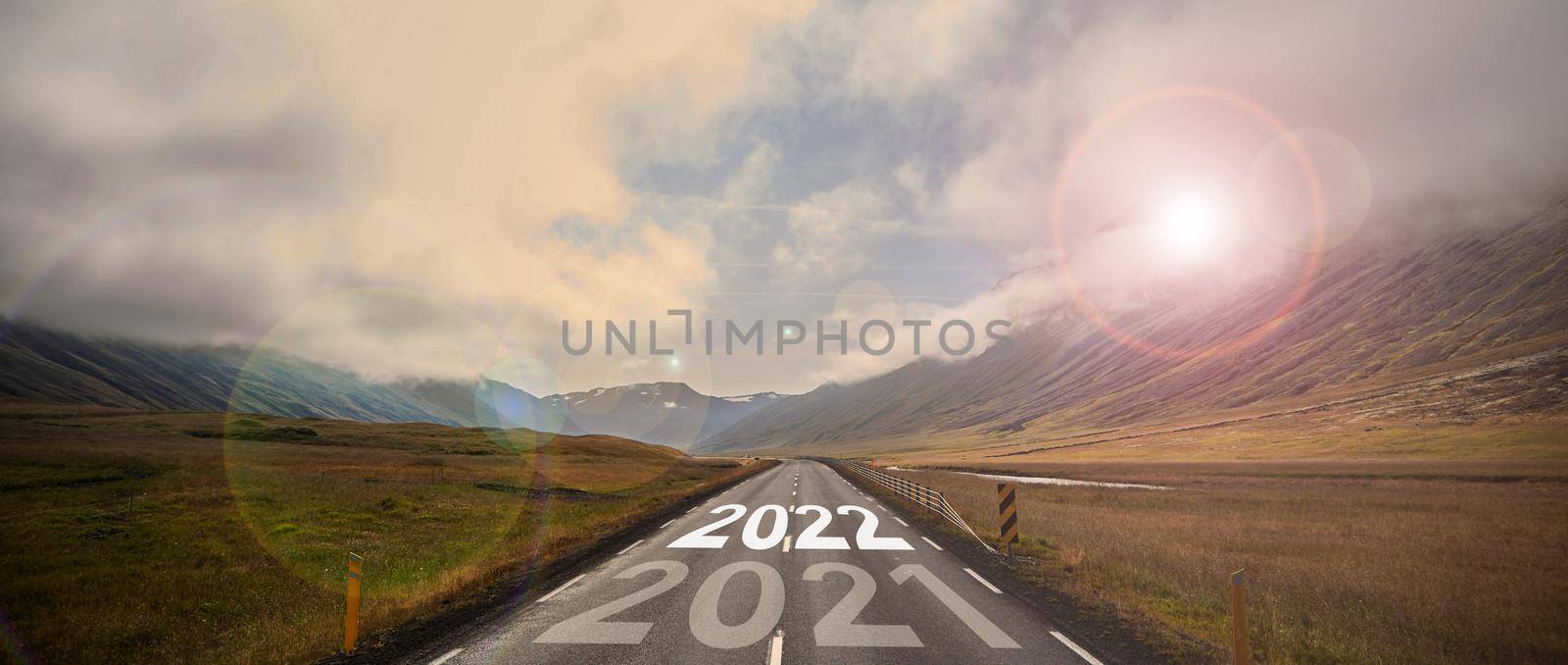 The word 2022 written on highway road in the middle of empty asphalt road by driver-s