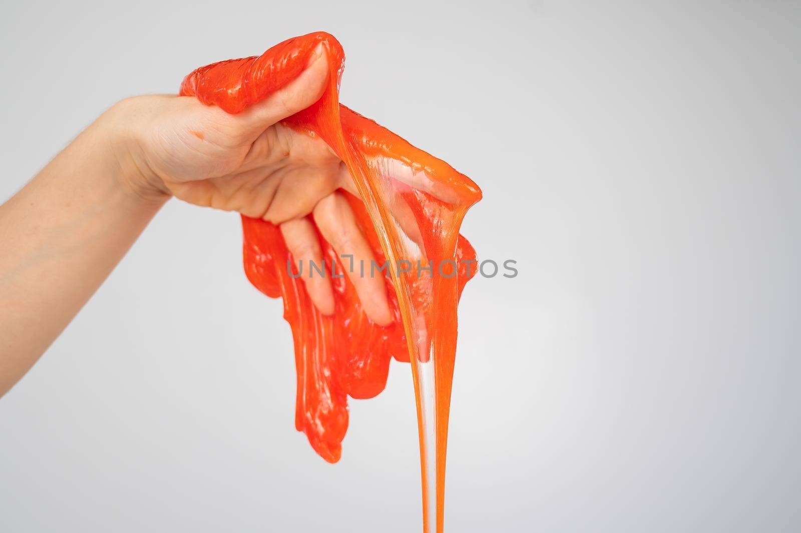 Red slime flowing down from a woman's hand on a white background