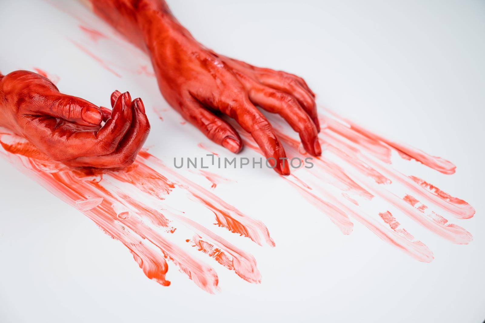 Female hands in blood on a white background