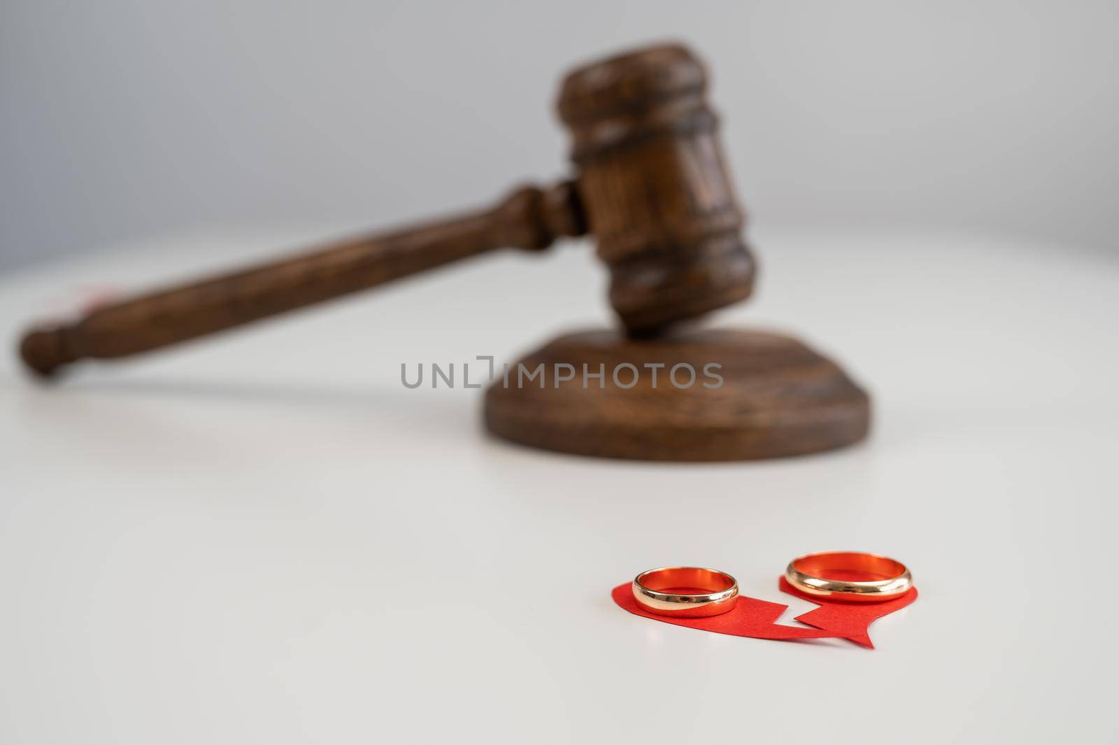 Judicial gavel broken heart and wedding rings. by mrwed54