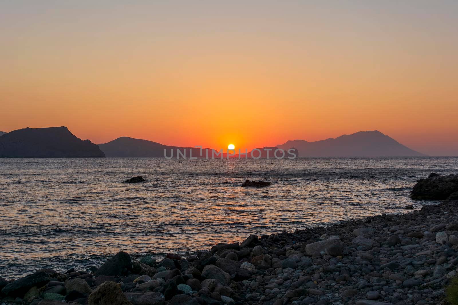 Beautiful sunset at a beach of Greek island of Milos.