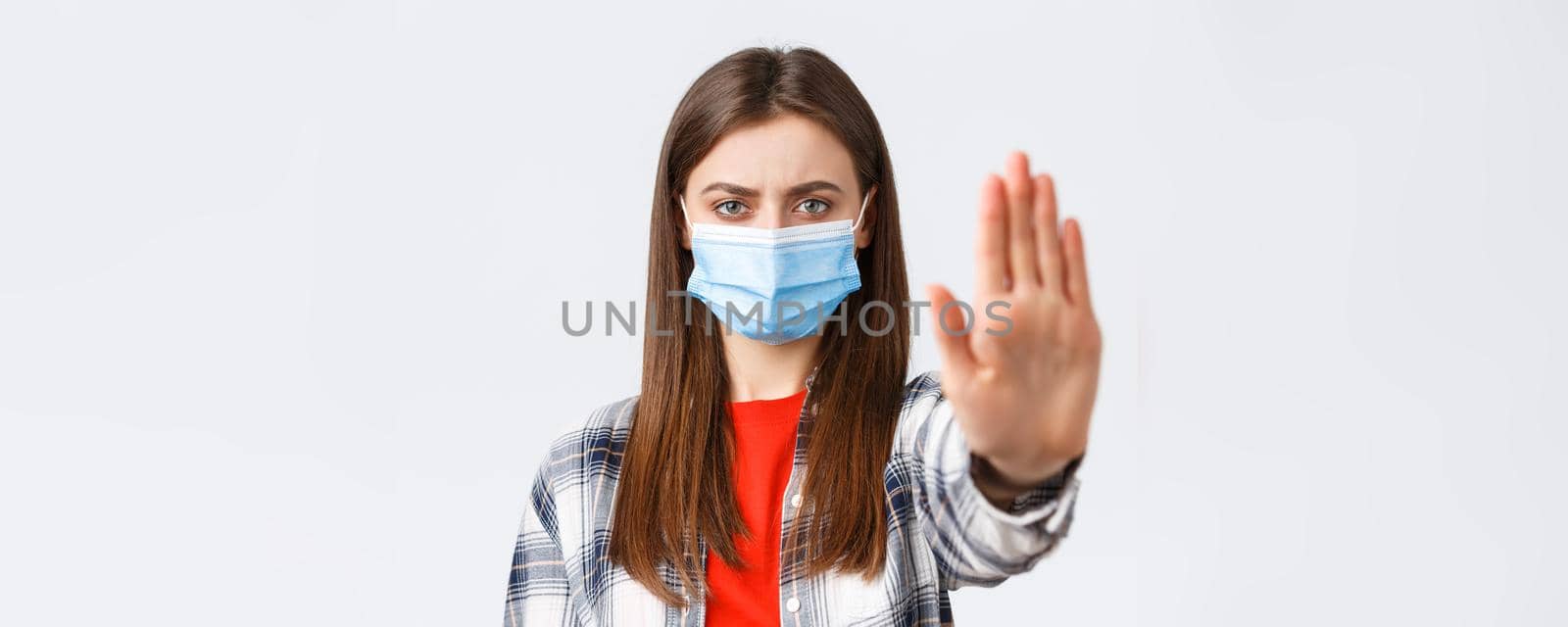 Coronavirus outbreak, leisure on quarantine, social distancing and emotions concept. Close-up of serious determined young woman want prevent or stop smth, stretch hand in restriction or warning.