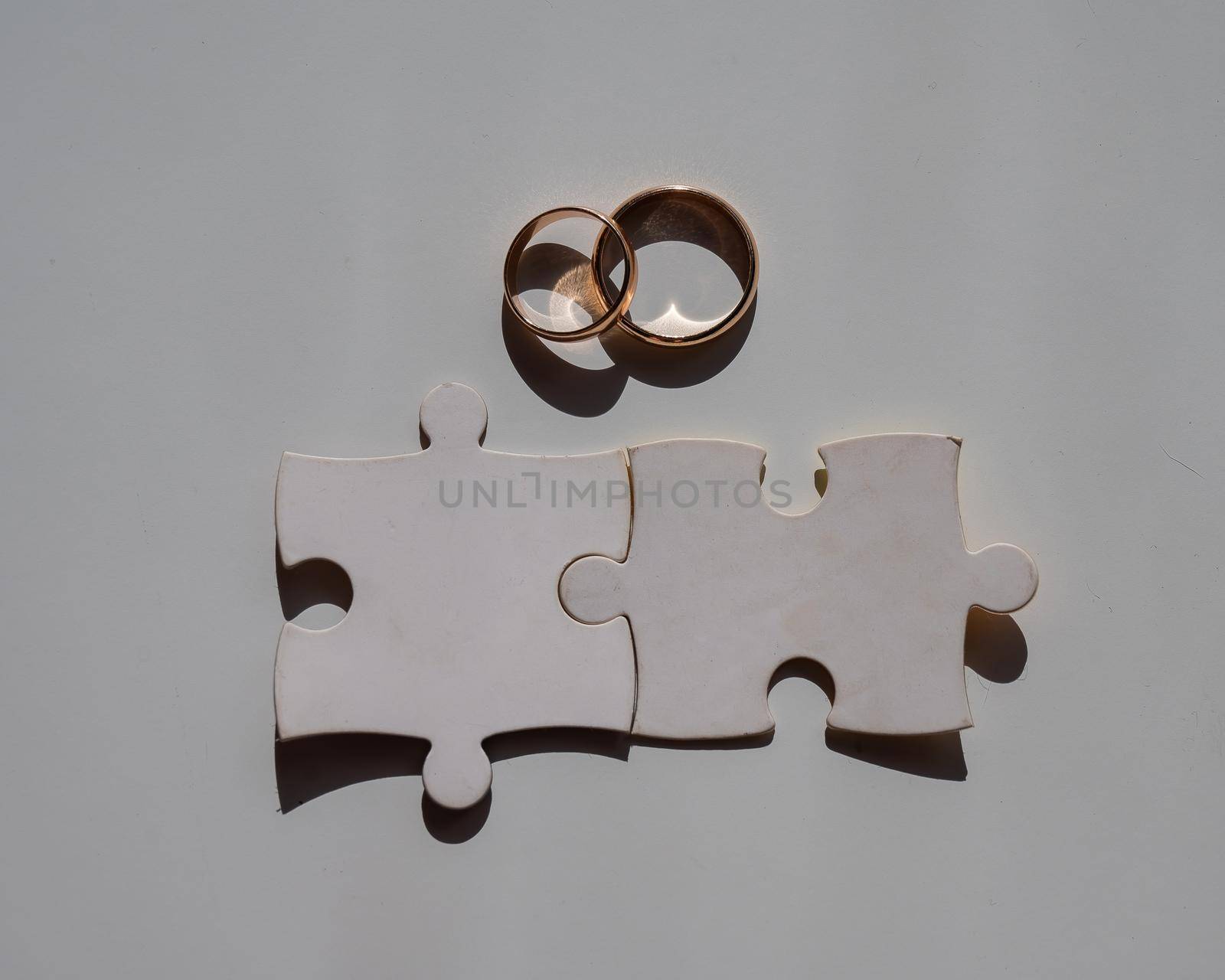 Wedding rings and puzzle pieces. Husband and wife complement each other perfectly. by mrwed54