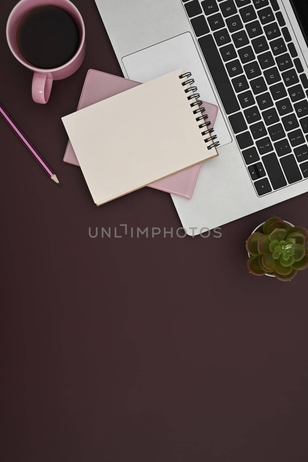 Flat lay computer laptop, notepad and coffee cup on purple background. by prathanchorruangsak