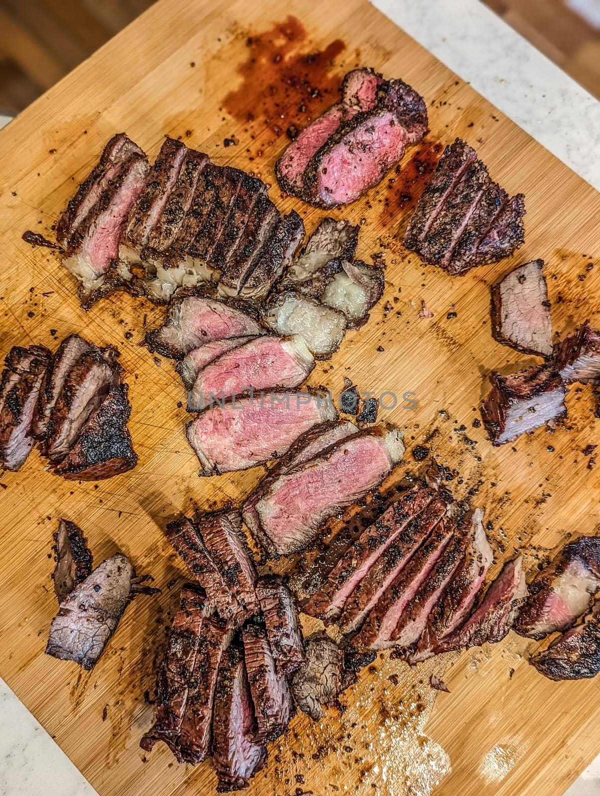cooked and sliced to perfection 30 day dry aged ny strip beef and bison ribeye