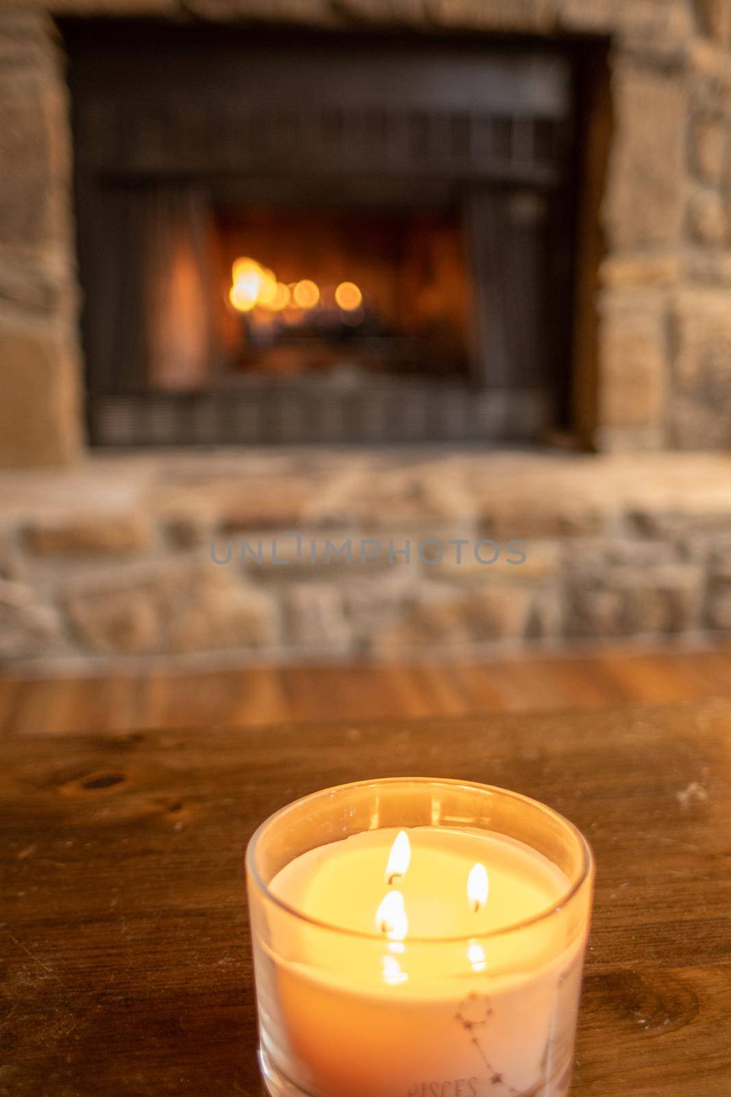 cozy indoor fireplace and candle sitting in living room