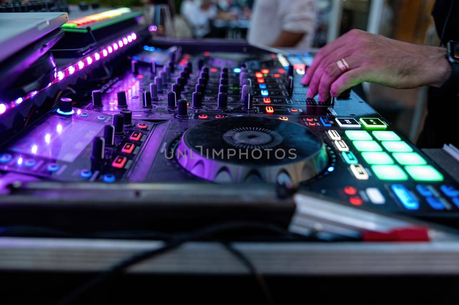 console with DJ during a disco party by carfedeph
