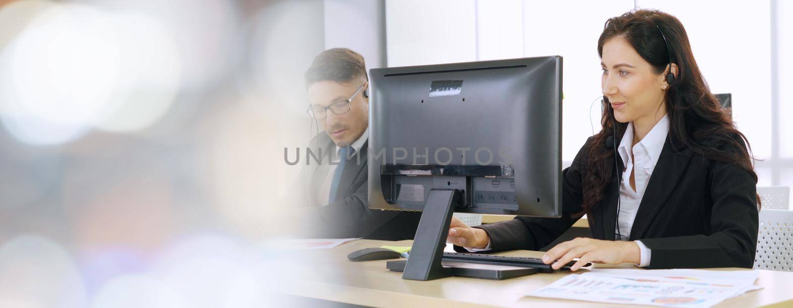 Business people wearing headset working in office broaden view by biancoblue