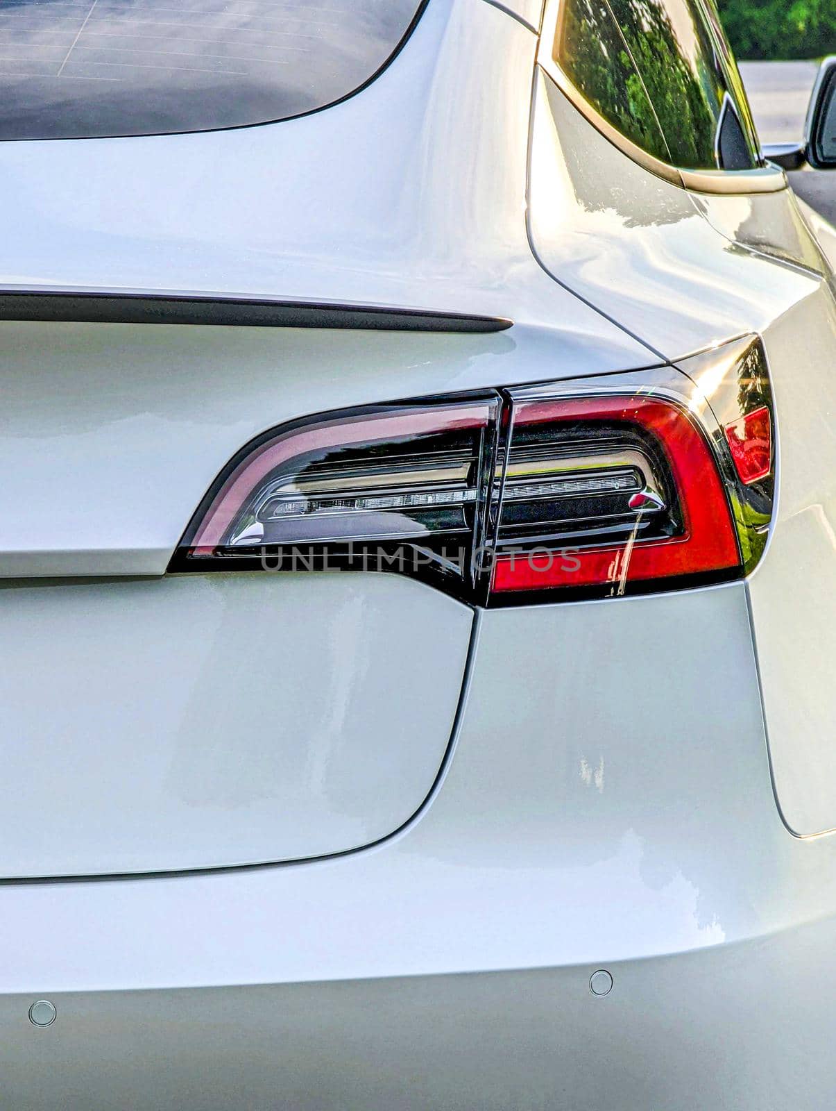 rear view of bumper and trunk and lights of electrical vehicle by digidreamgrafix