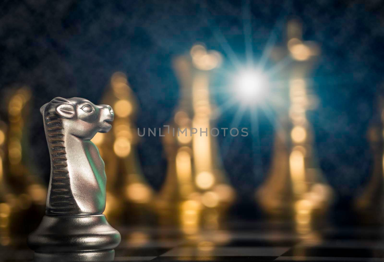 Silver knight chess pieces facing in front gold chess on board with flare light to successfully in the competition. Management or leadership strategy and teamwork concept. by Chakreeyarut