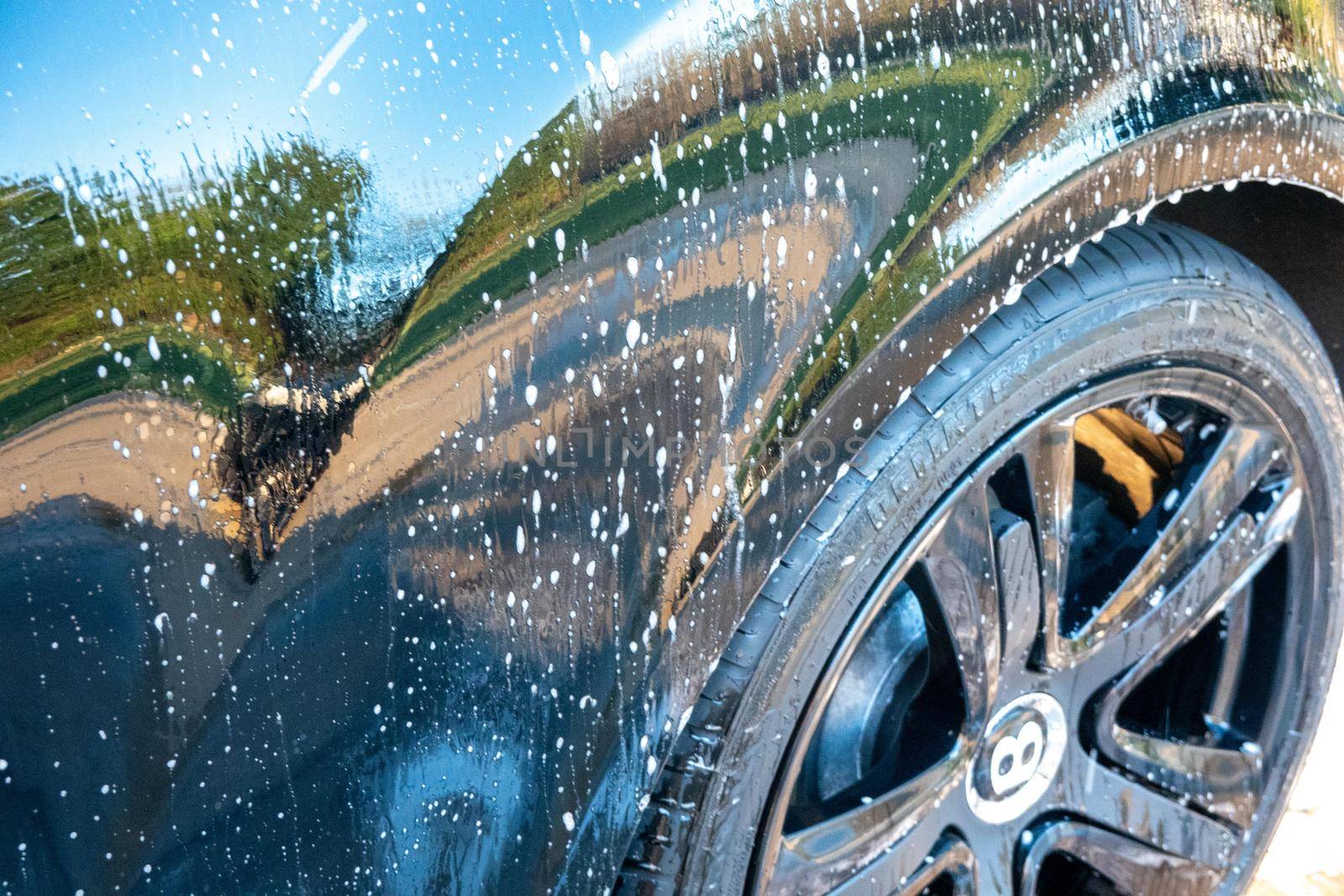 car detailer washing auto with soap by digidreamgrafix