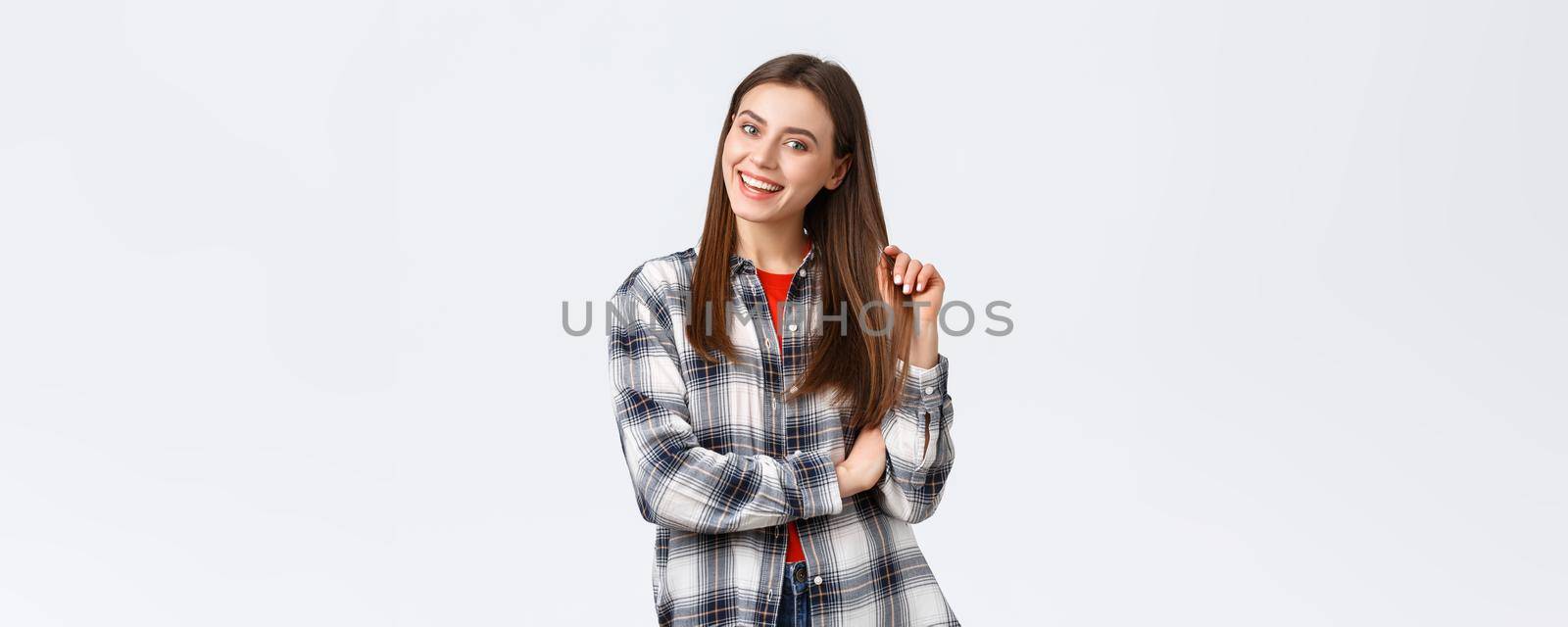 Lifestyle, different emotions, leisure activities concept. Enthusiastic and intrigued attractive girl looking with interest, picking products in store, smiling and touching haircut, casual outfit by Benzoix