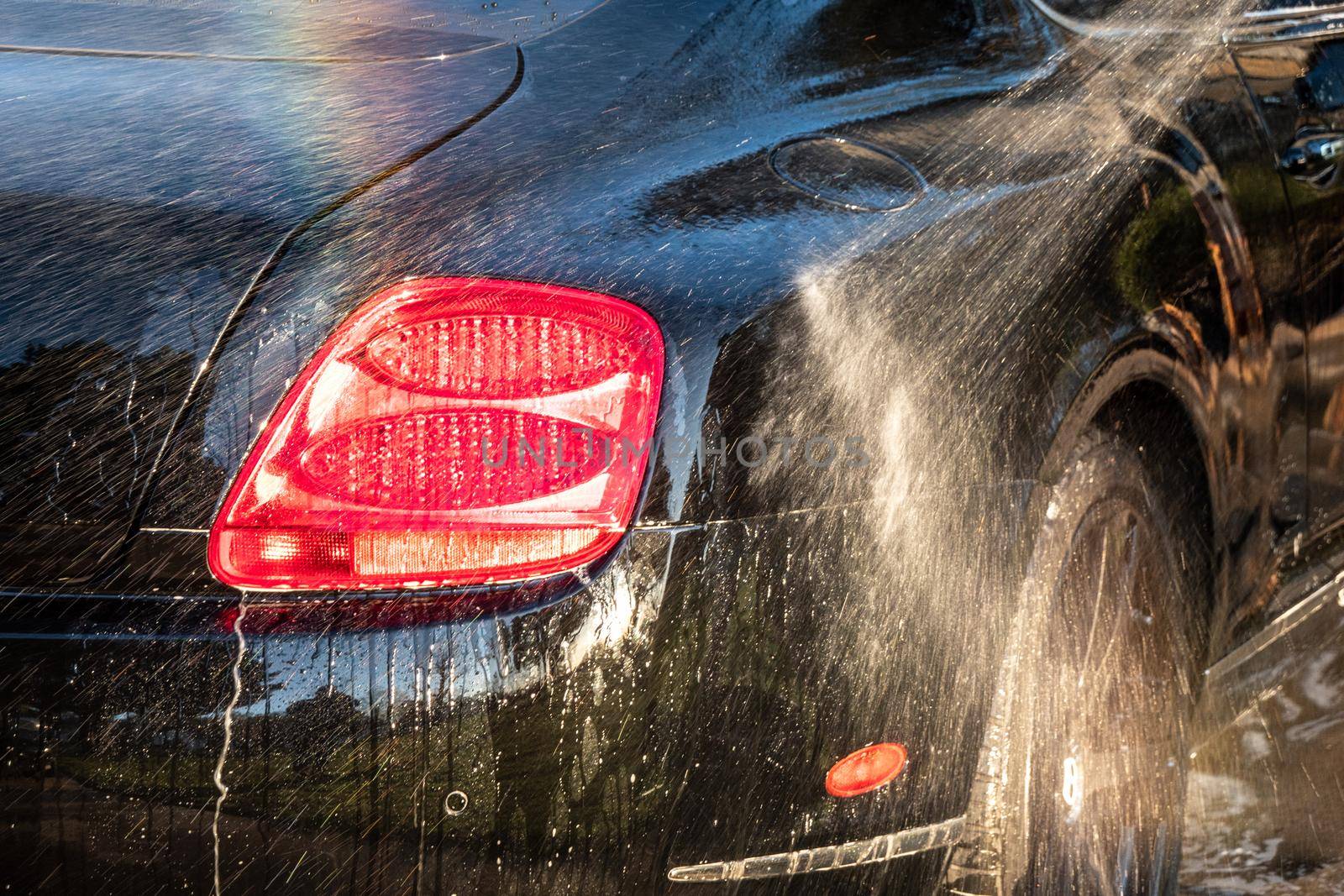 auto detailer washing luxury high end car