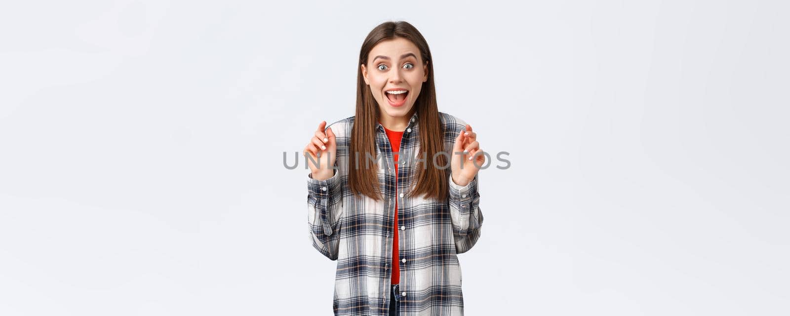 Lifestyle, different emotions, leisure activities concept. Excited and happy young attractive woman hear great news, rehoicing, congratulating friend, smiling upbeat and jumping from joy by Benzoix