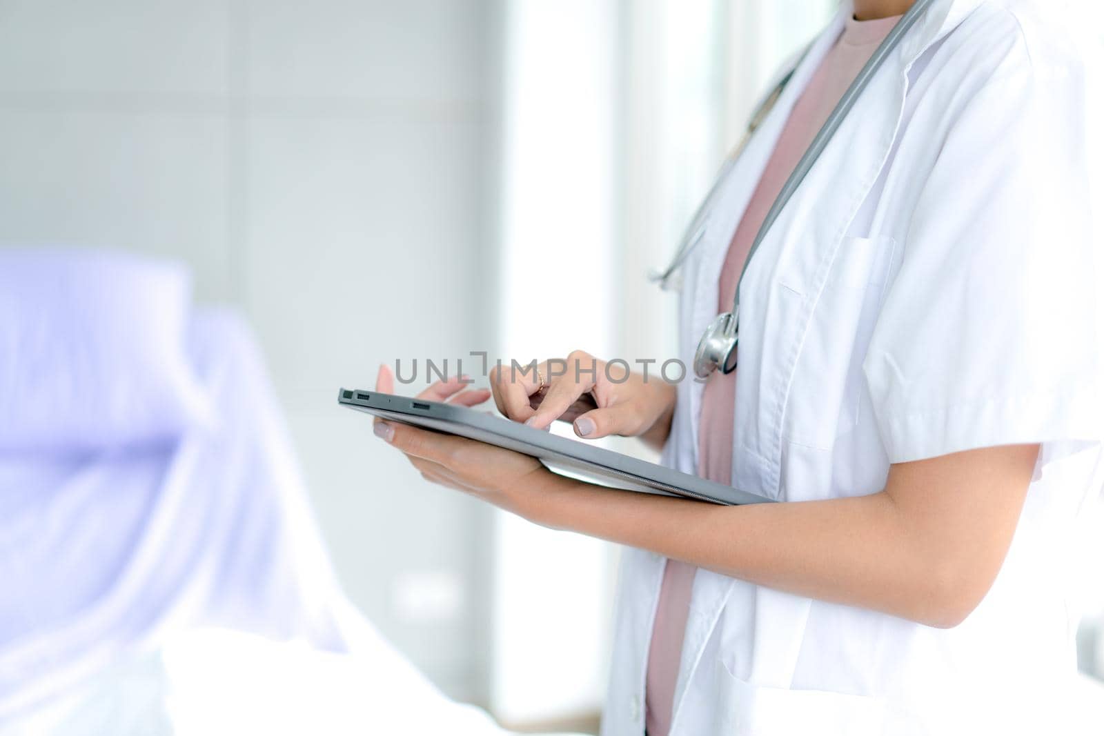 Telemedicine concept.  Hands doctor using tablet computer. Doctor online virtual consultation, chatting to patient, video call, virtual appointment on app. by Buttus_casso