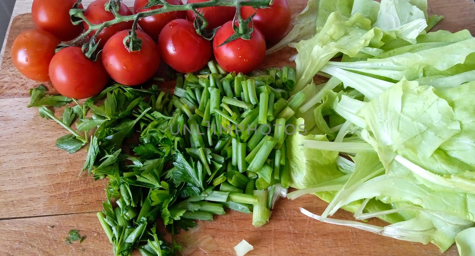 Fresh vegetables for salad or tortilla. Tomatoes, salad, greenery. Food photography.