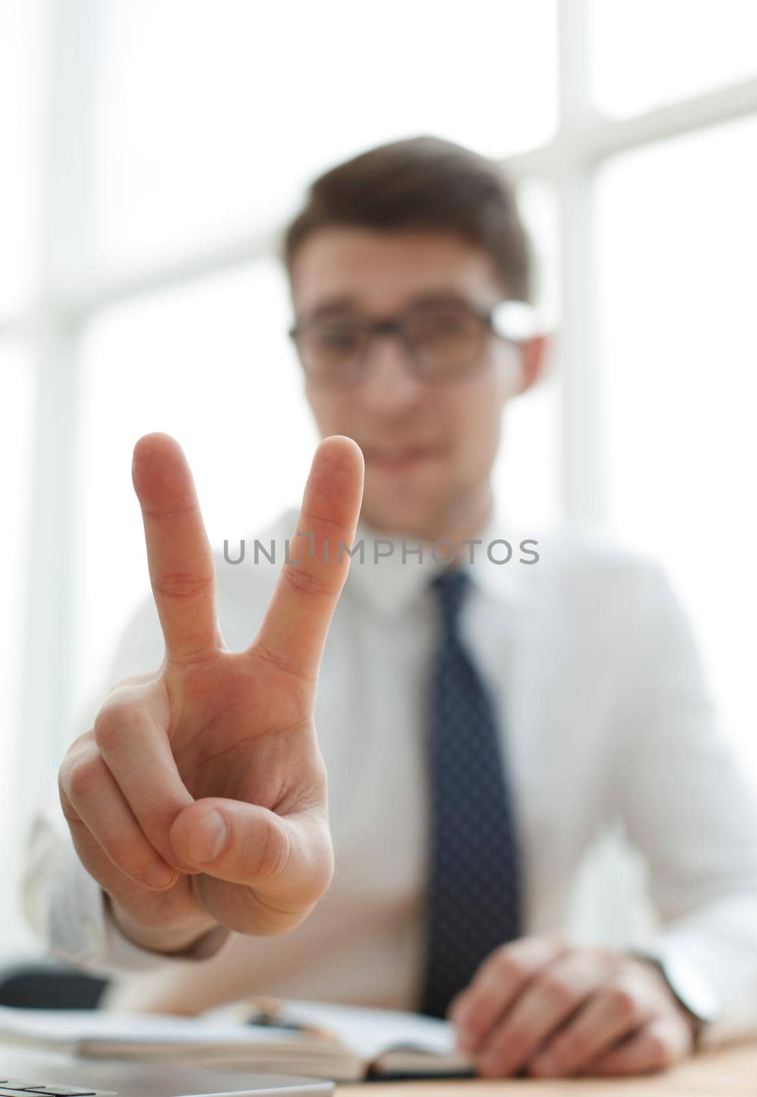 Young businessman man showing number two with fingers on hand by Prosto