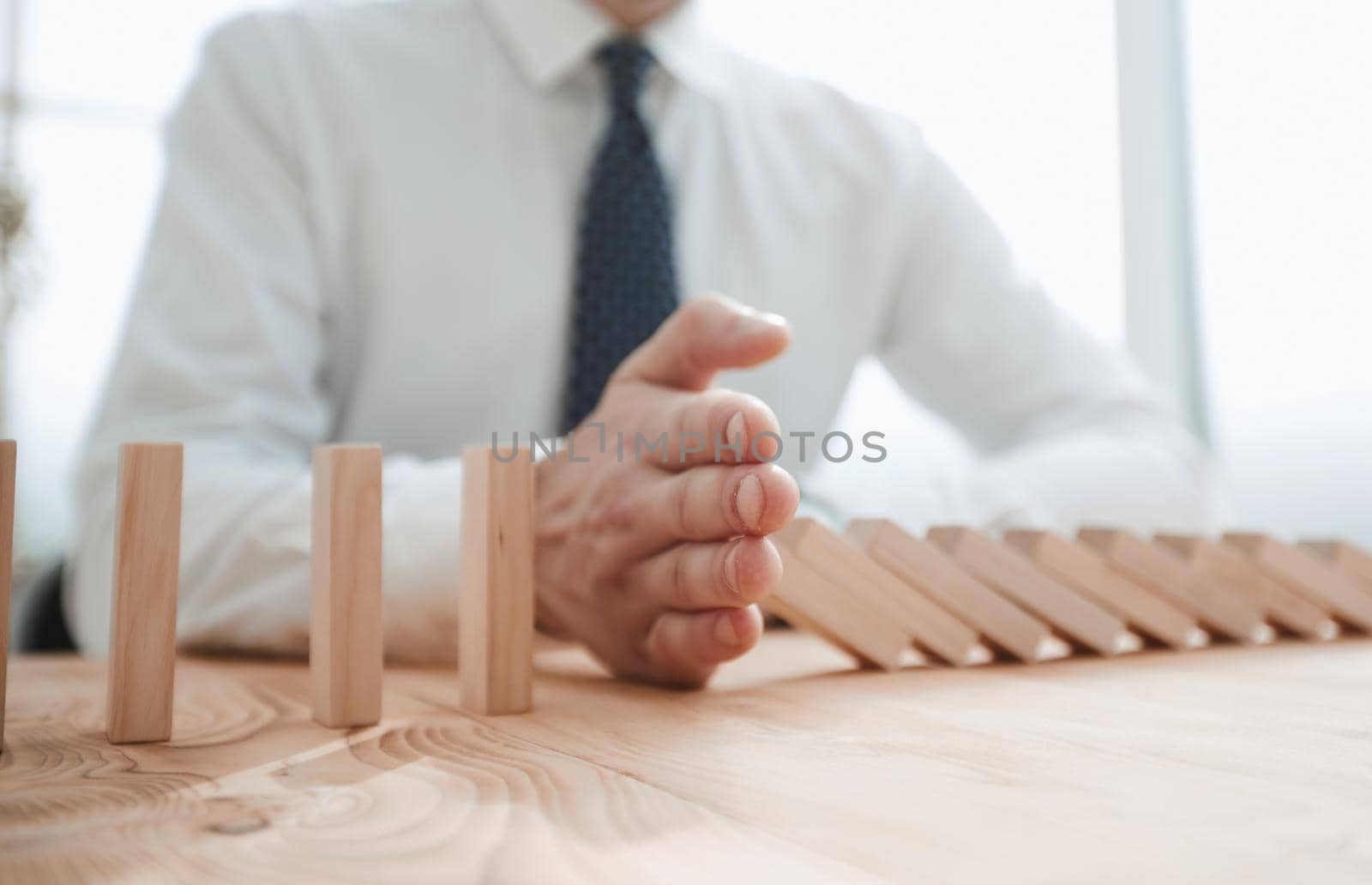Businessman with dominoes in the office. concept business risk by Prosto