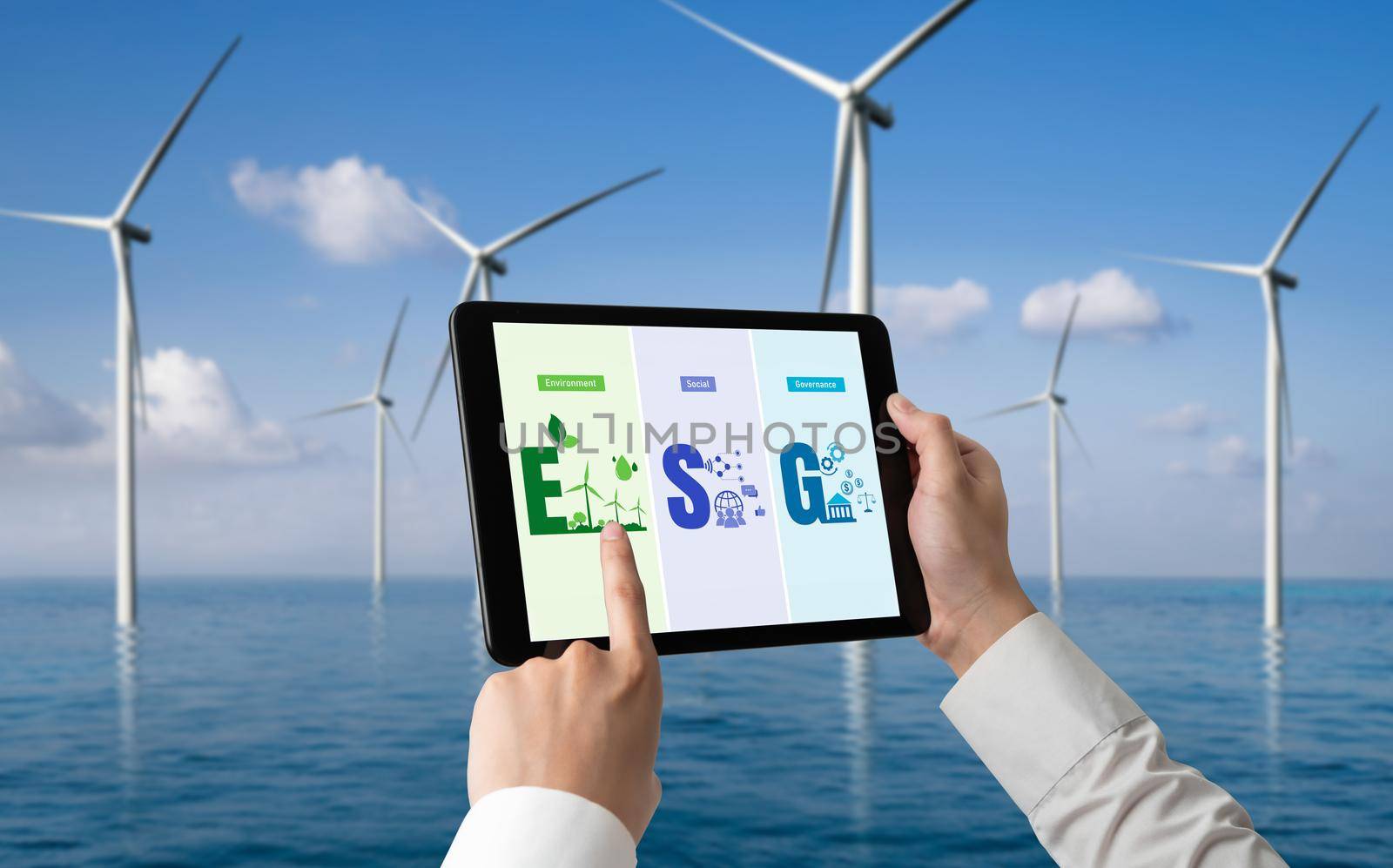 Green business transformation for environment saving and ESG business concept. Businessman using tablet to set corporate goal toward environmental friendly management and alternative clean energy use.