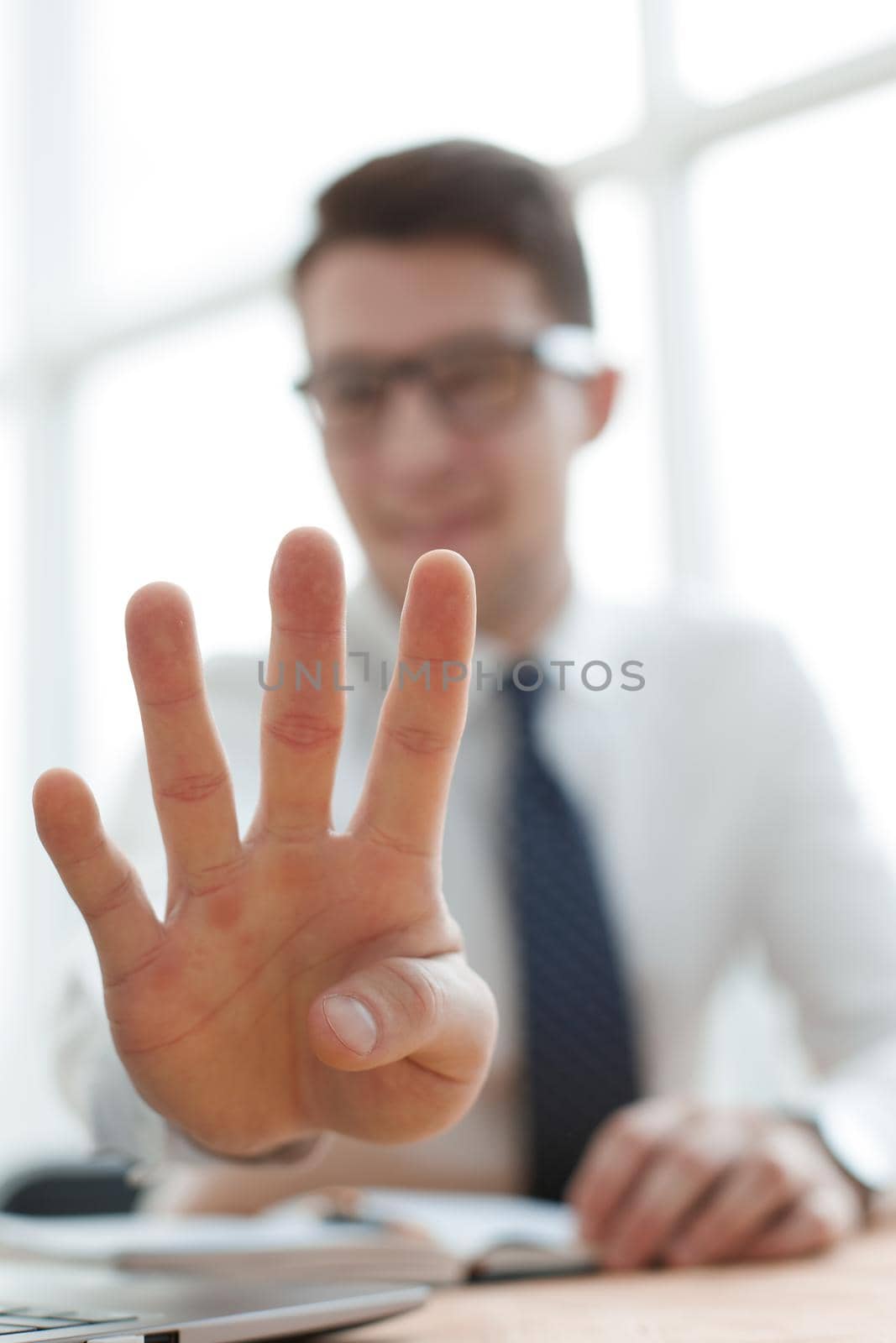 Young businessman man showing number four with fingers on hand by Prosto