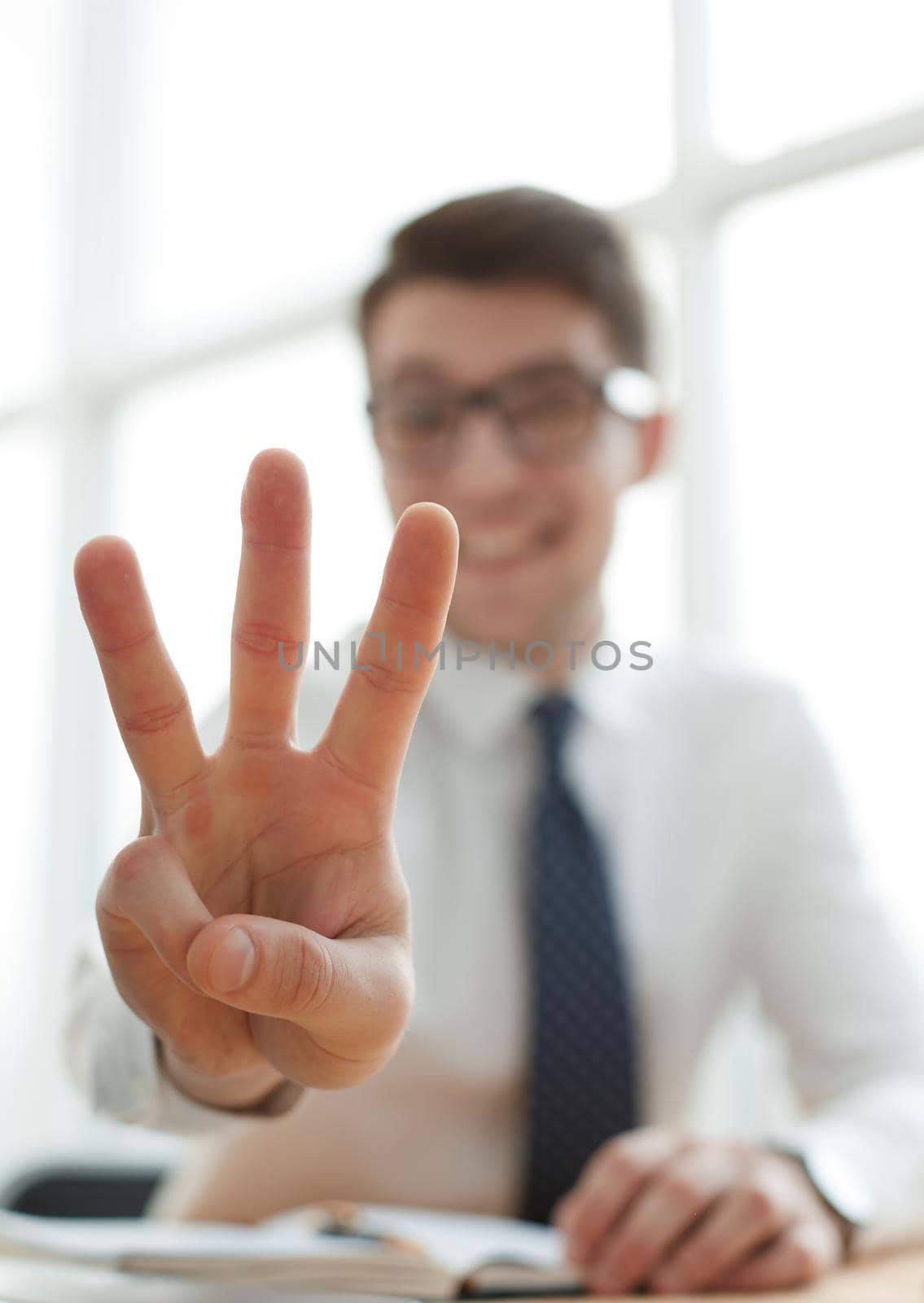 Young businessman man showing number three with fingers on hand by Prosto