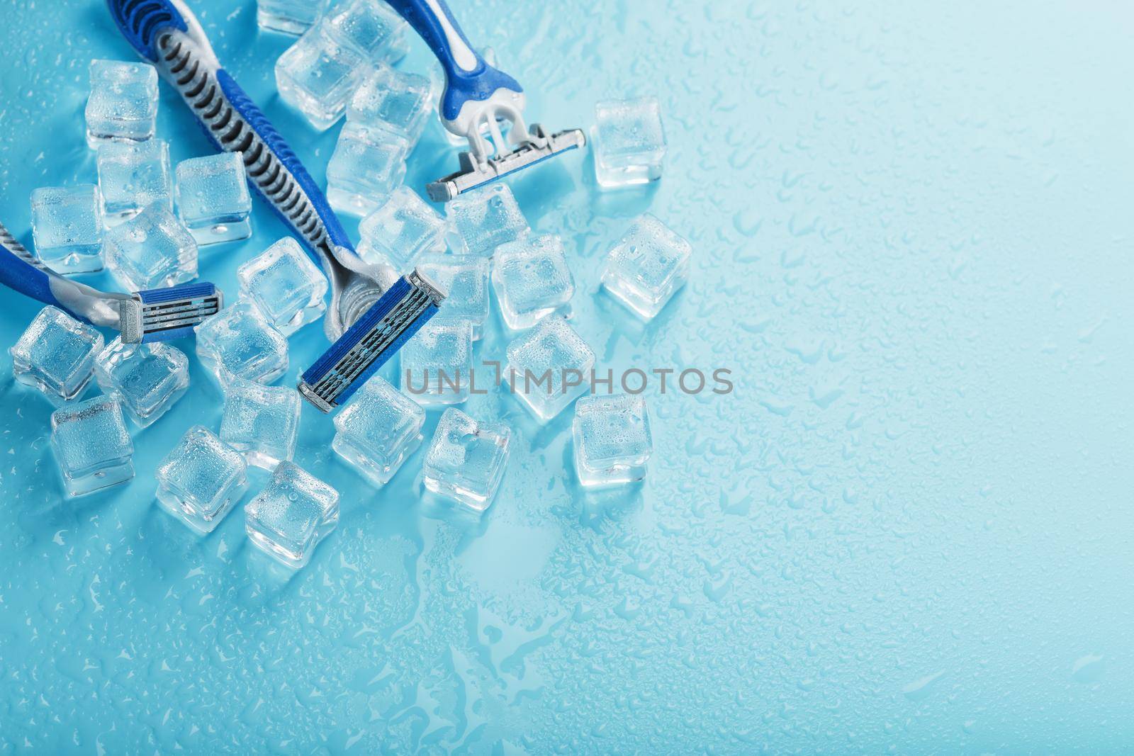 Refreshing shaving machines for the face against the background of frosty ice cubes by AlexGrec
