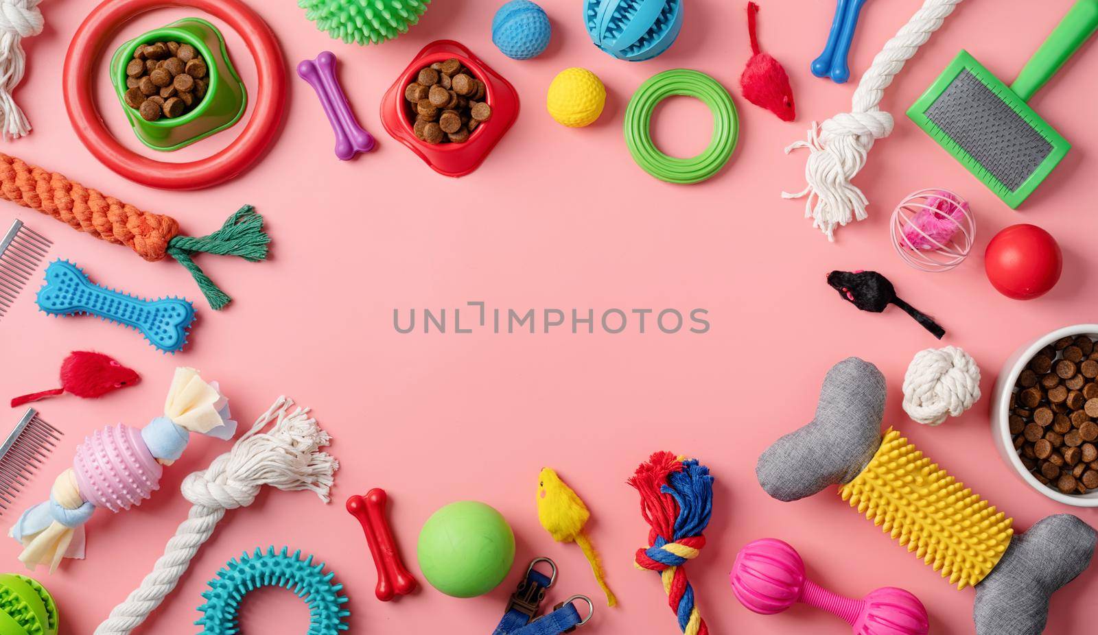 Pet care concept, various pet accessories and tools, toys, balls, brushes on pink background, flat lay