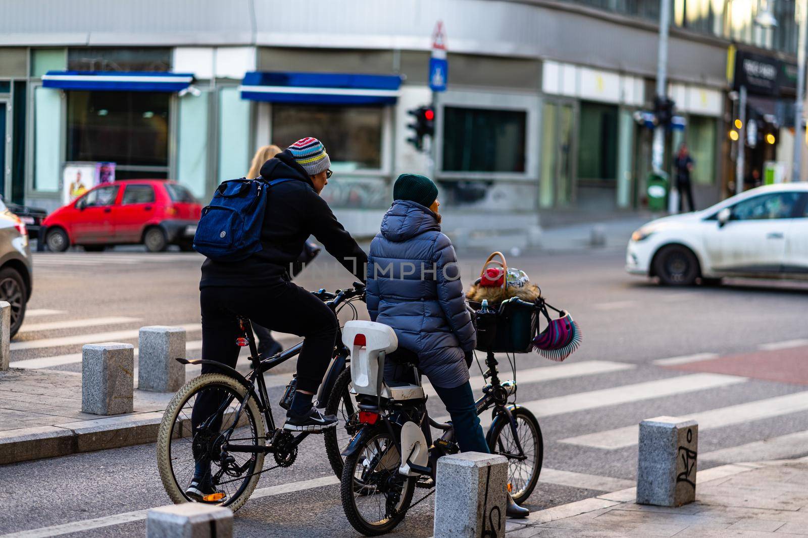 Riding a bicycle on the city streets. Commute to work in Bucharest, Romania, 2022 by vladispas