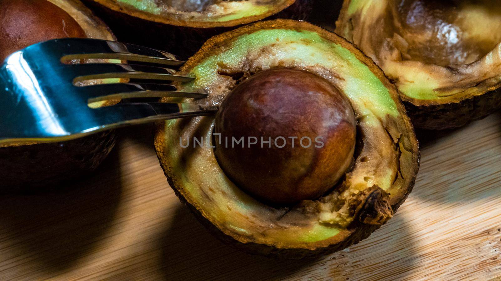 Close up Bad Avocado. Ugly Tropical fruits. Contaminated Avocado halfs. Necomestibile Fruits. Details Overripe Avocado. Unhelthy food Concept.