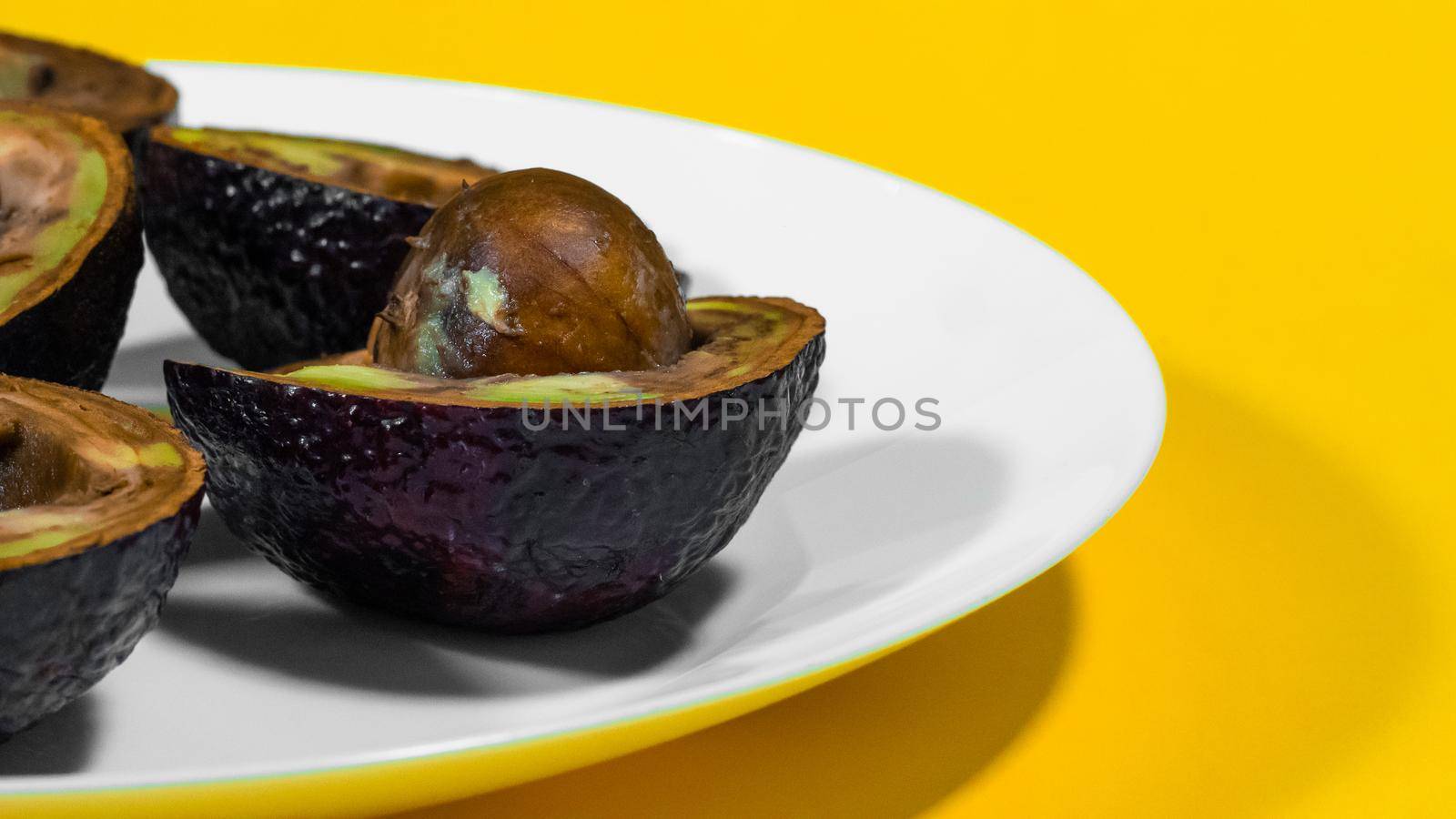 Yellow Background Bad Avocado Plate. by RecCameraStock