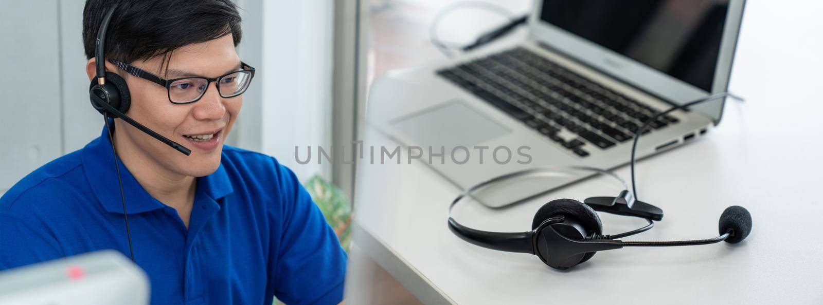 Business people wearing headset working in office in widen view by biancoblue