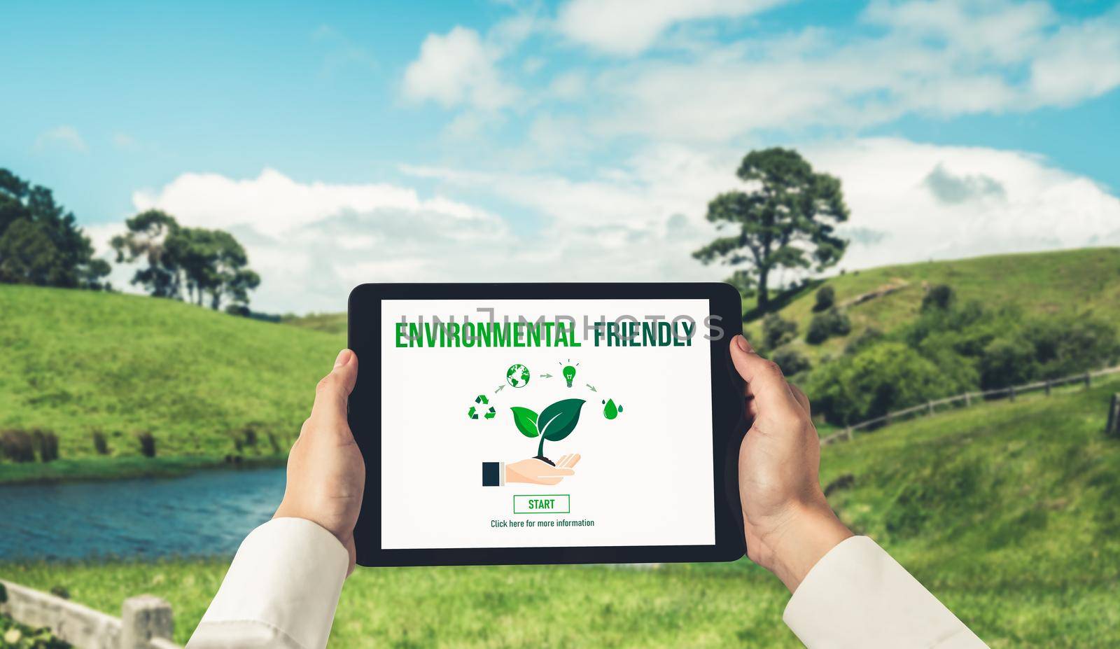 Green business transformation for environment saving and ESG business concept. Businessman using tablet to set corporate goal toward environmental friendly management and alternative clean energy use.