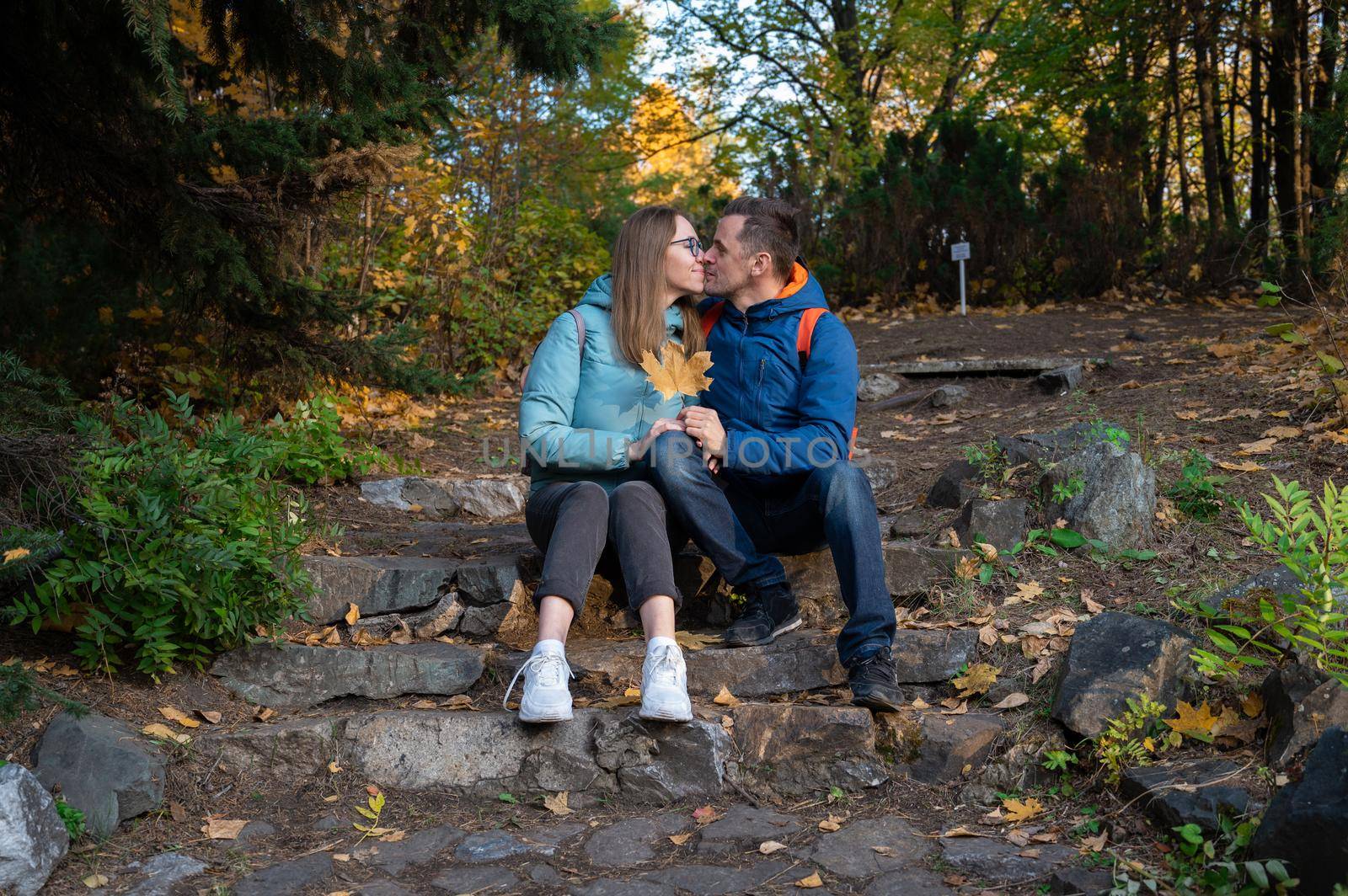 Happy couple in autumn park on fall nature background